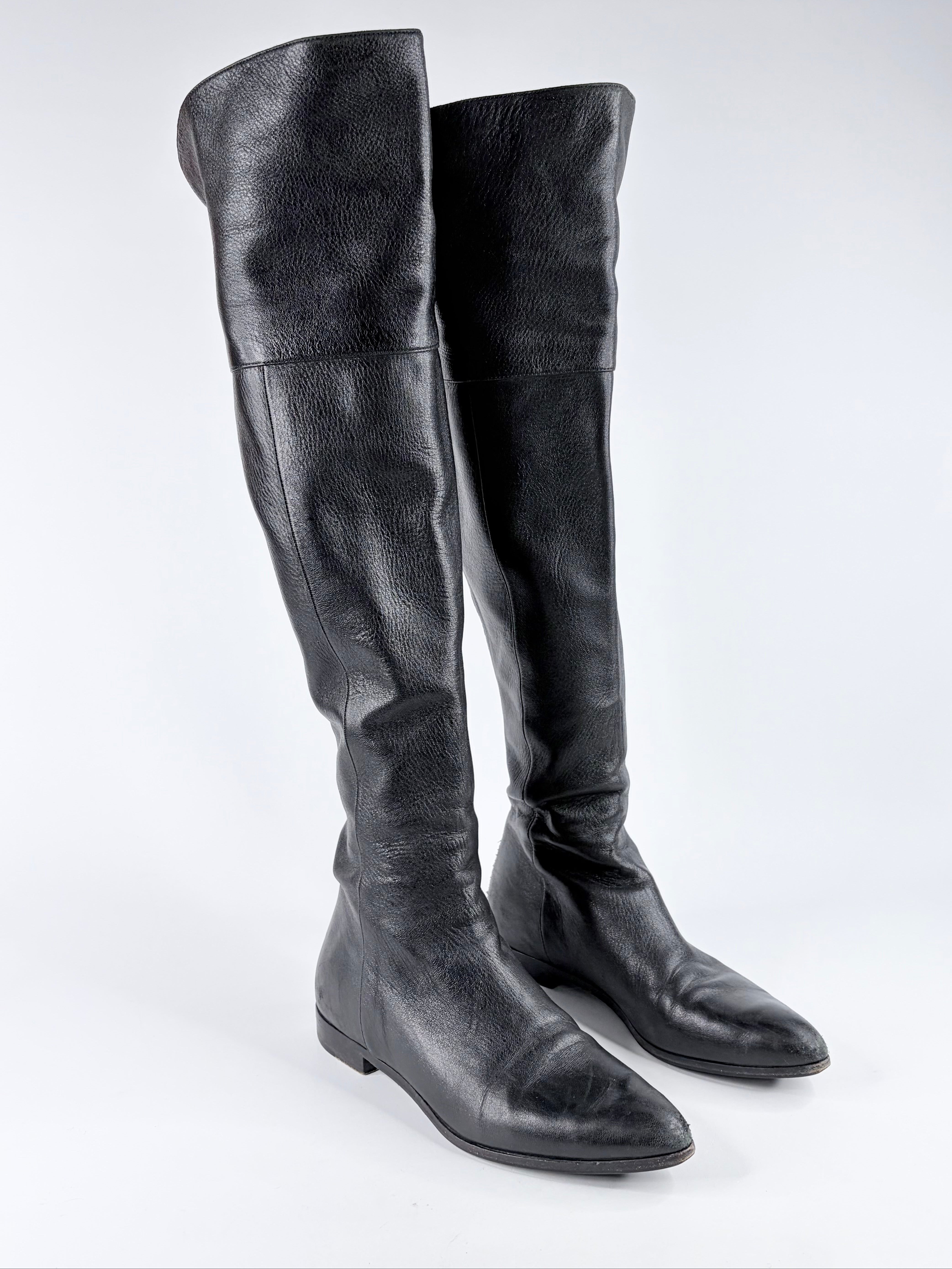 Pair of black knee-high boots on a white background