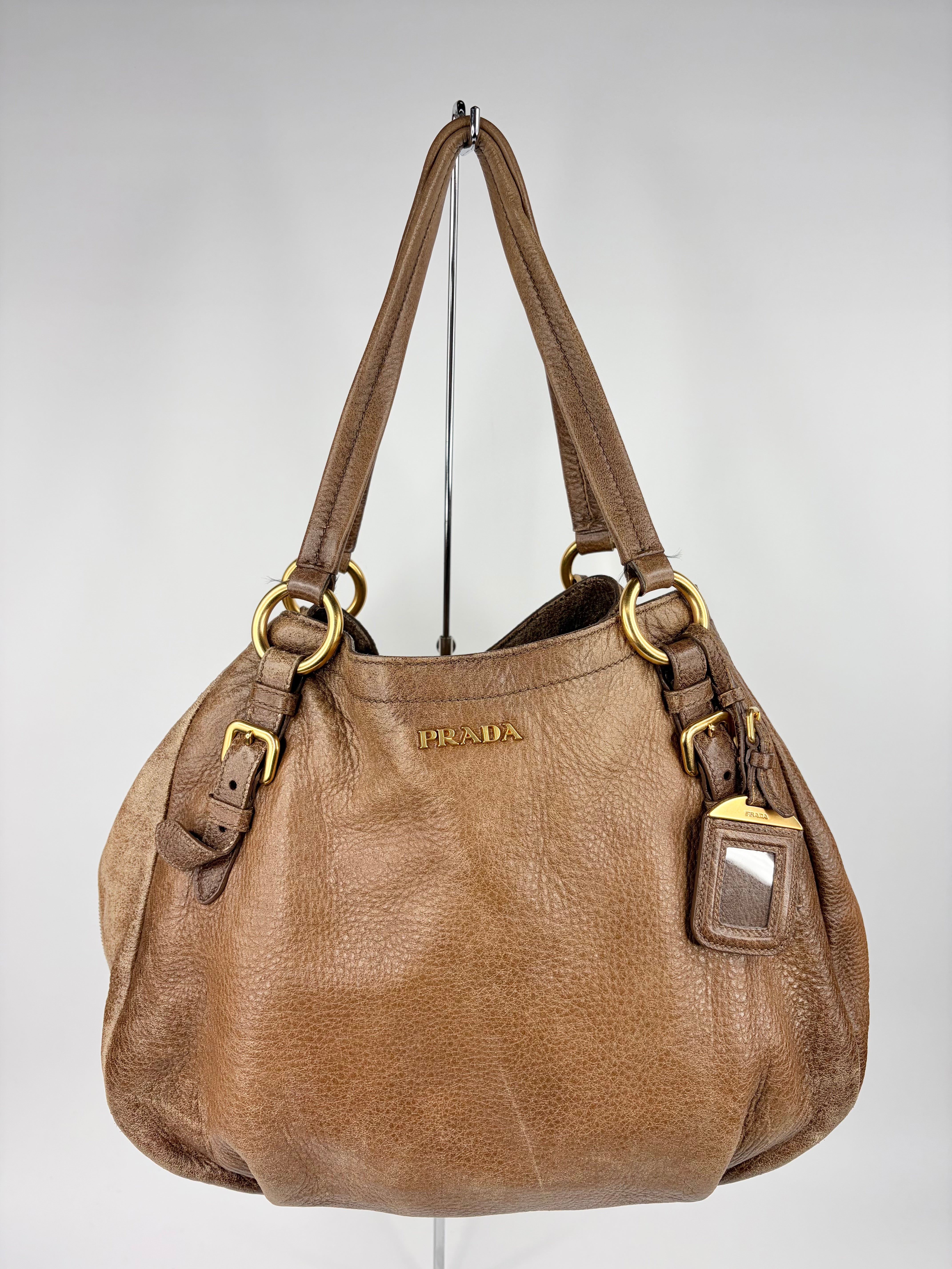 Brown Prada handbag on a white background