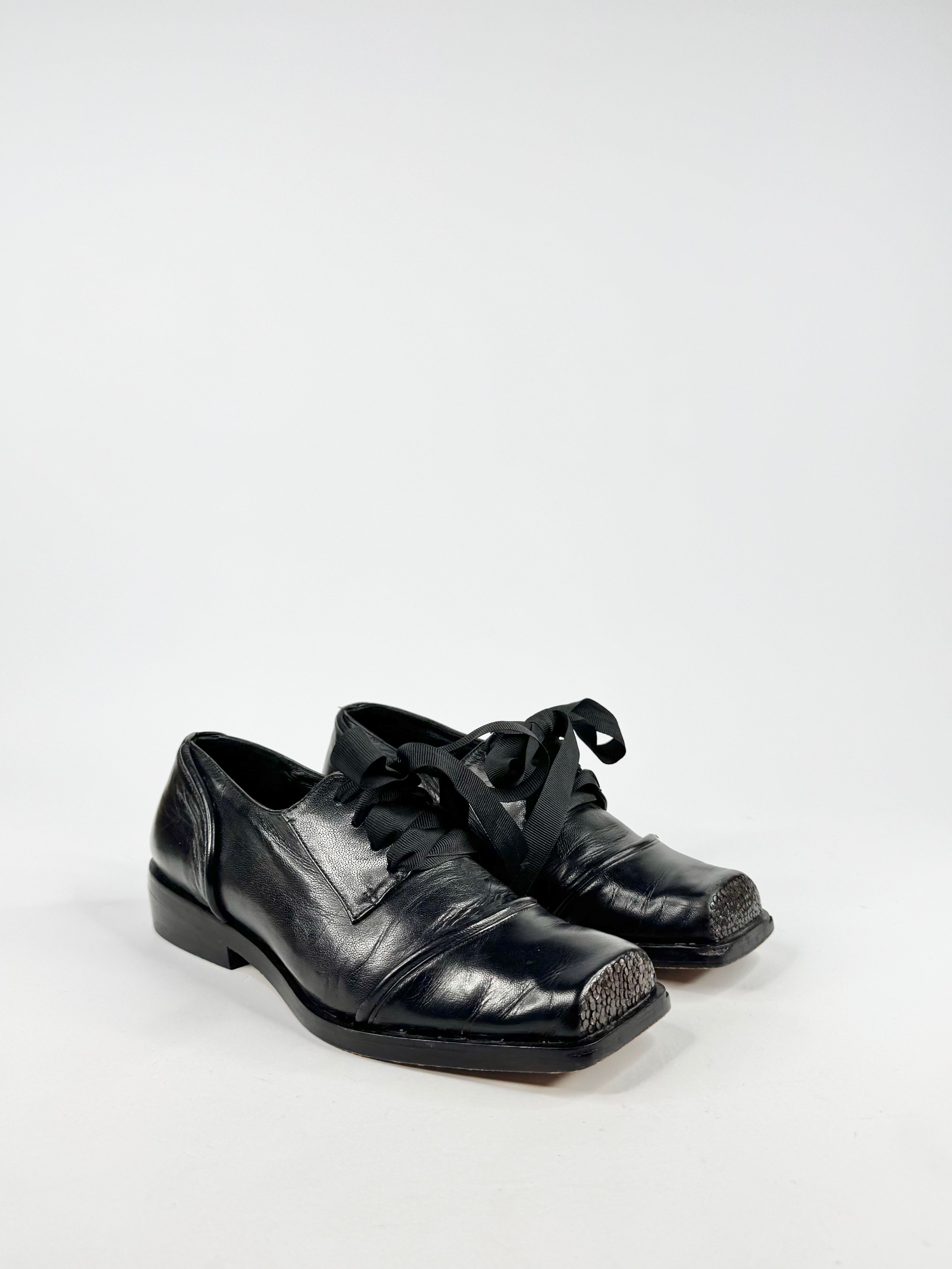 Pair of black leather shoes on a white background