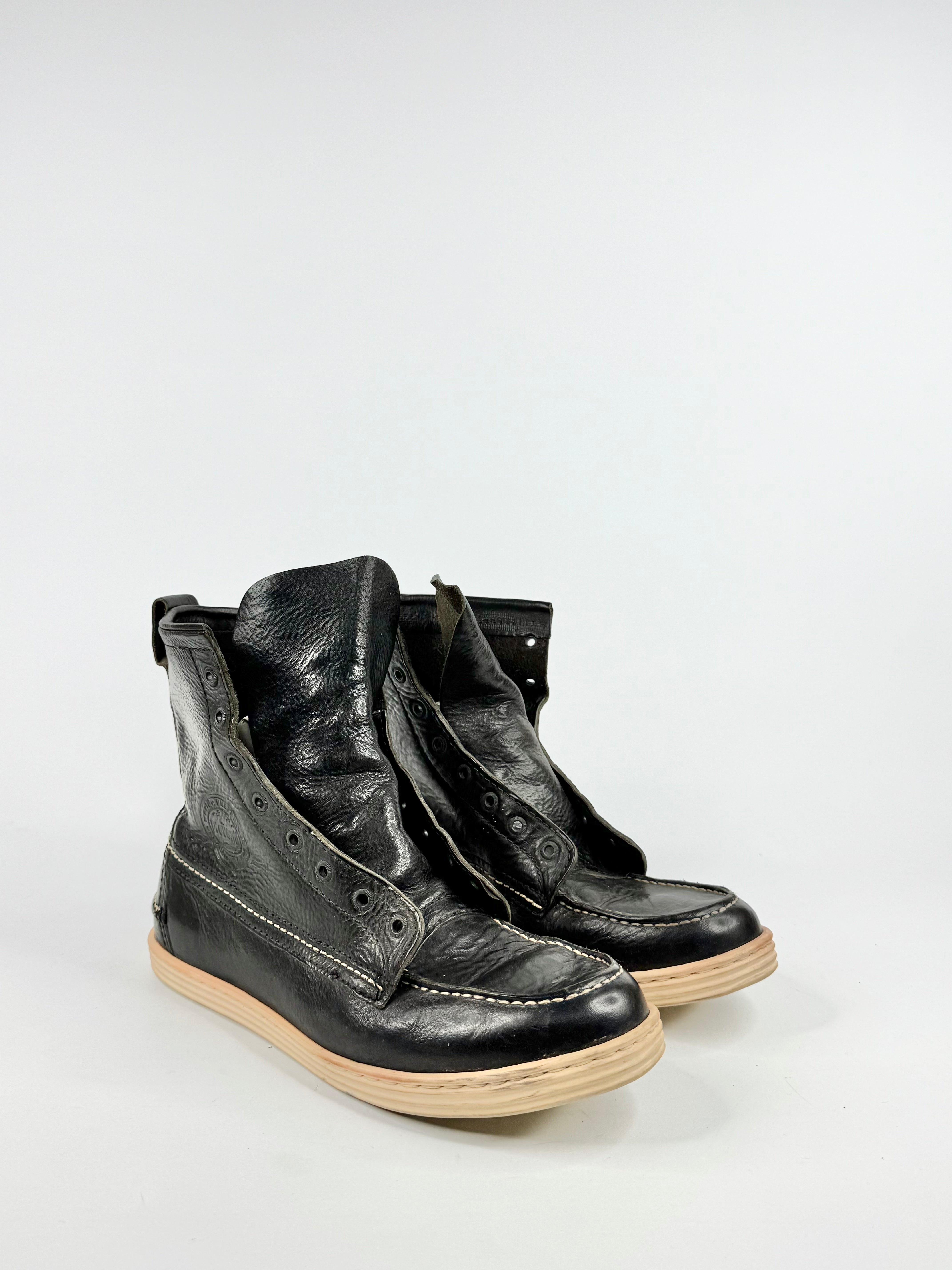 Pair of black leather boots on a white background