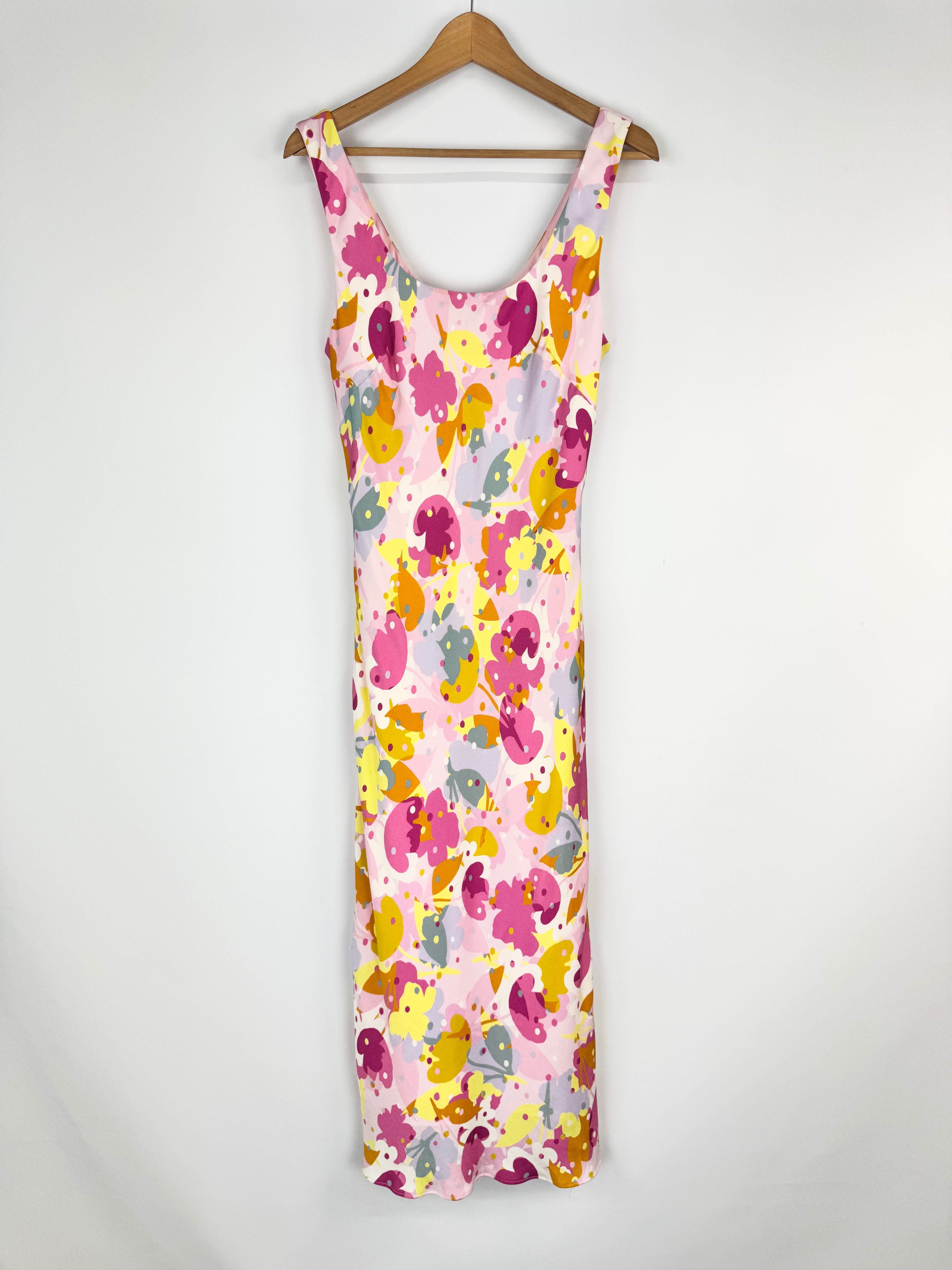Floral dress on a hanger against a white background