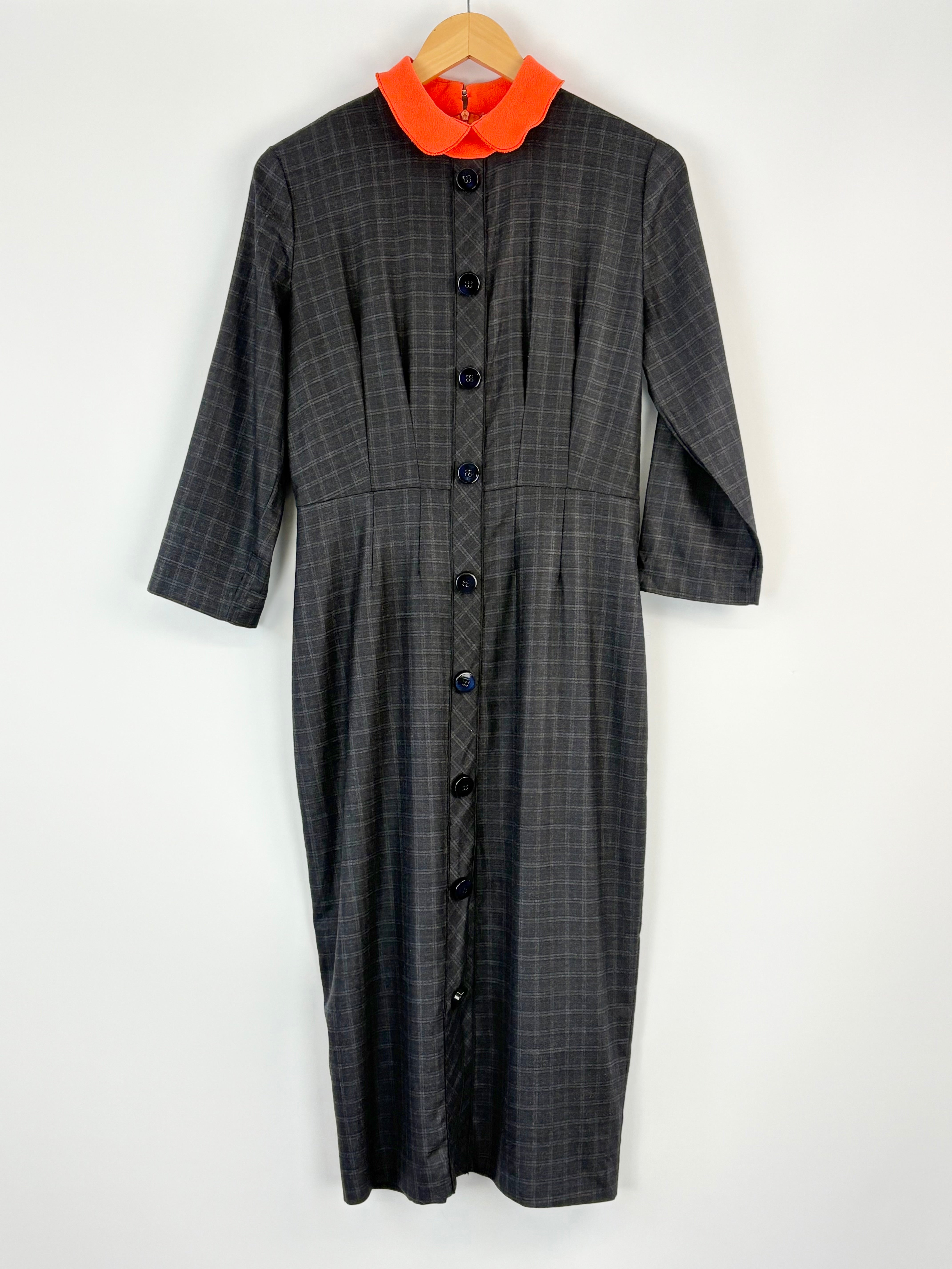 Gray checkered dress with orange collar on a white background