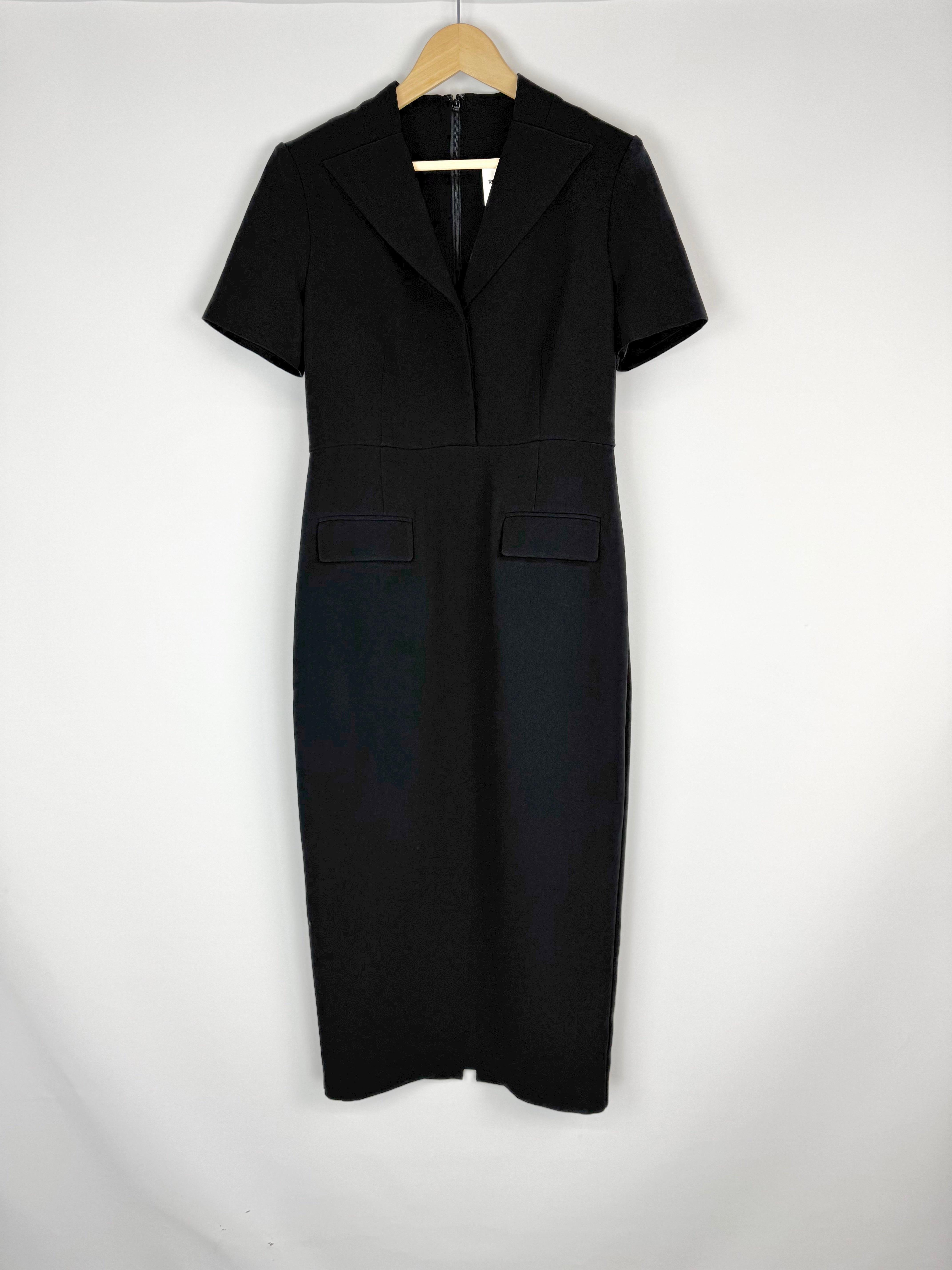 Black dress on a hanger against a white background