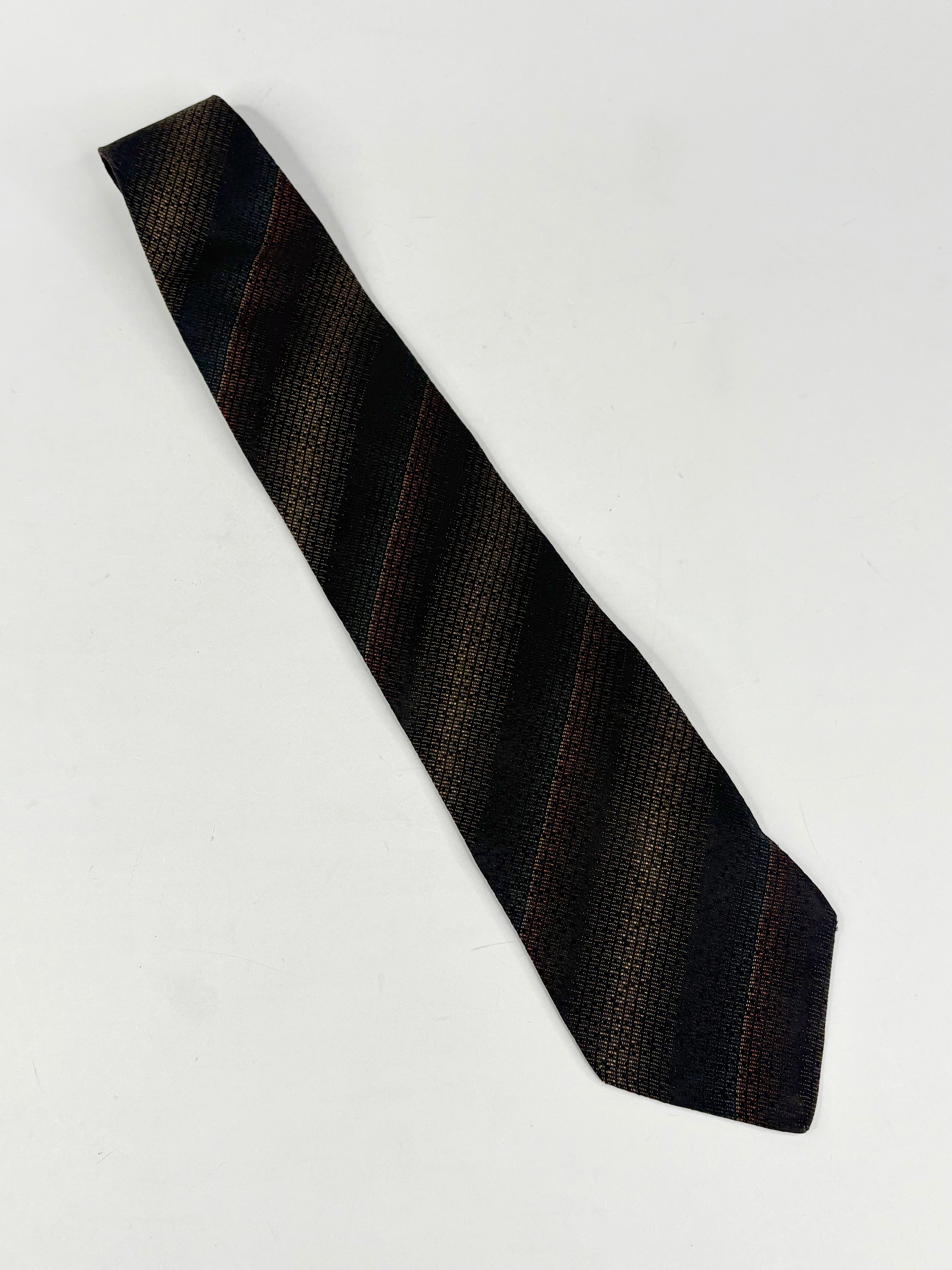 Black striped tie on a light gray background