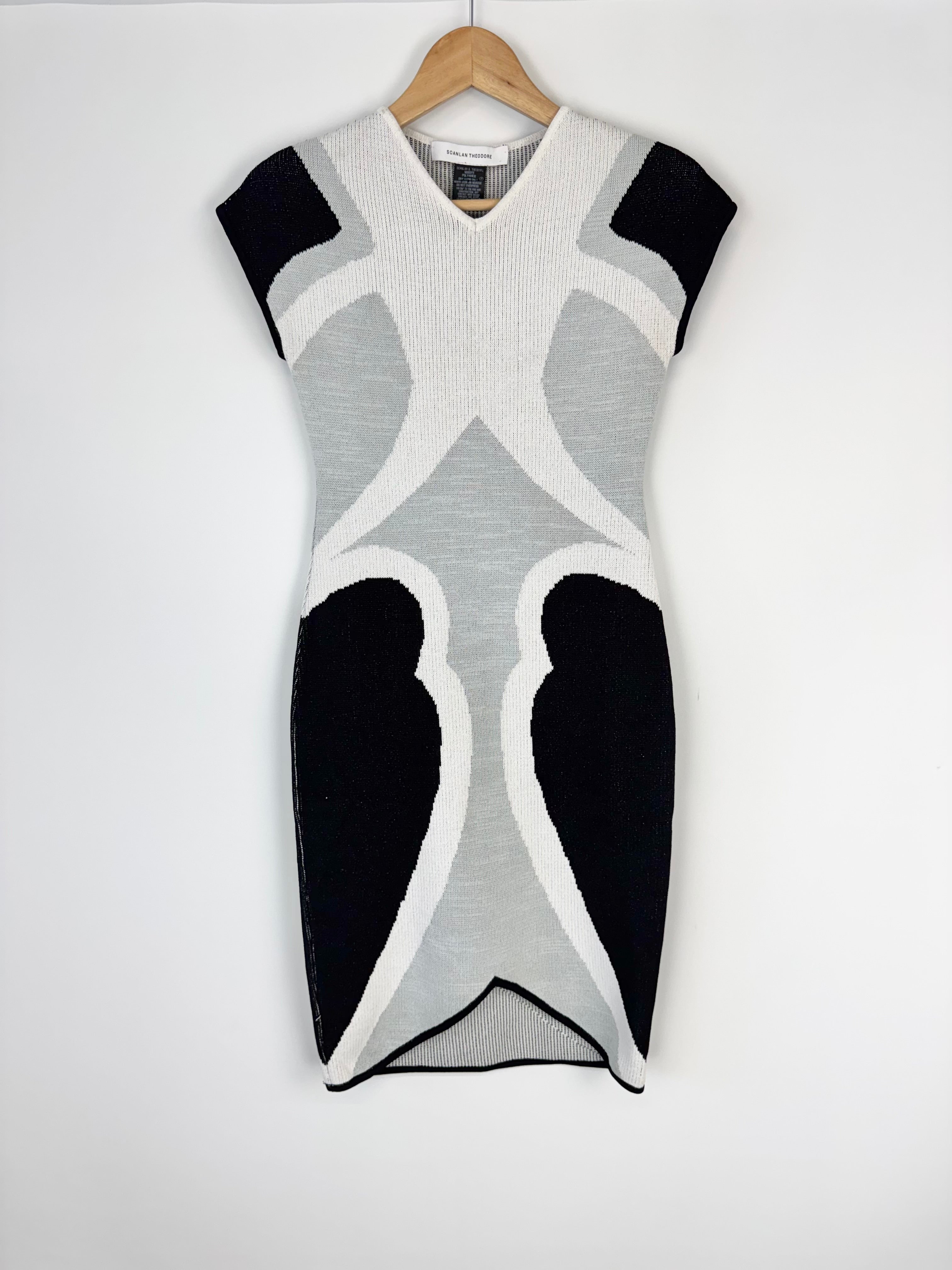 Gray and black patterned sleeveless dress on a hanger against a white background