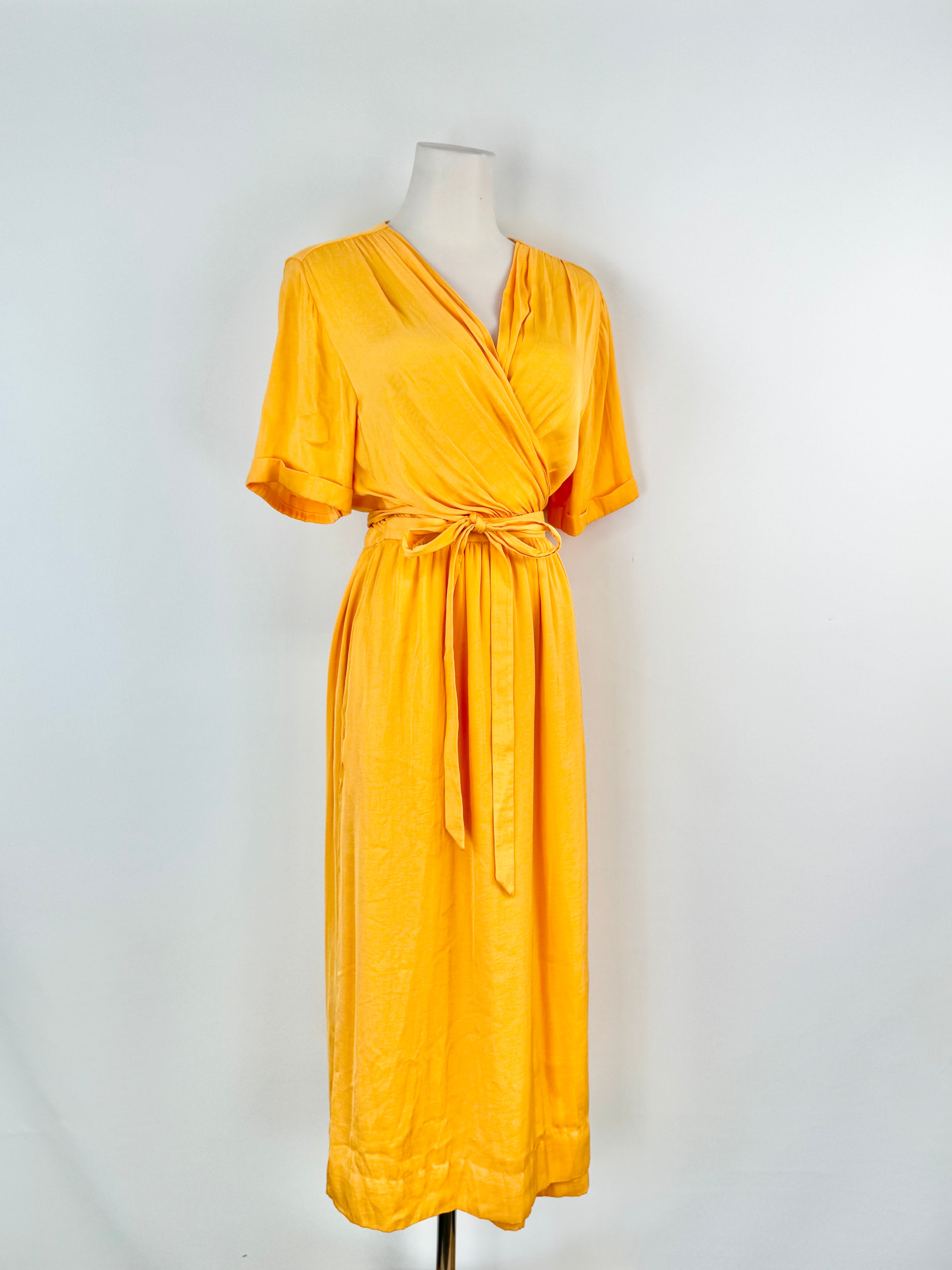 Yellow dress on a mannequin against a white background