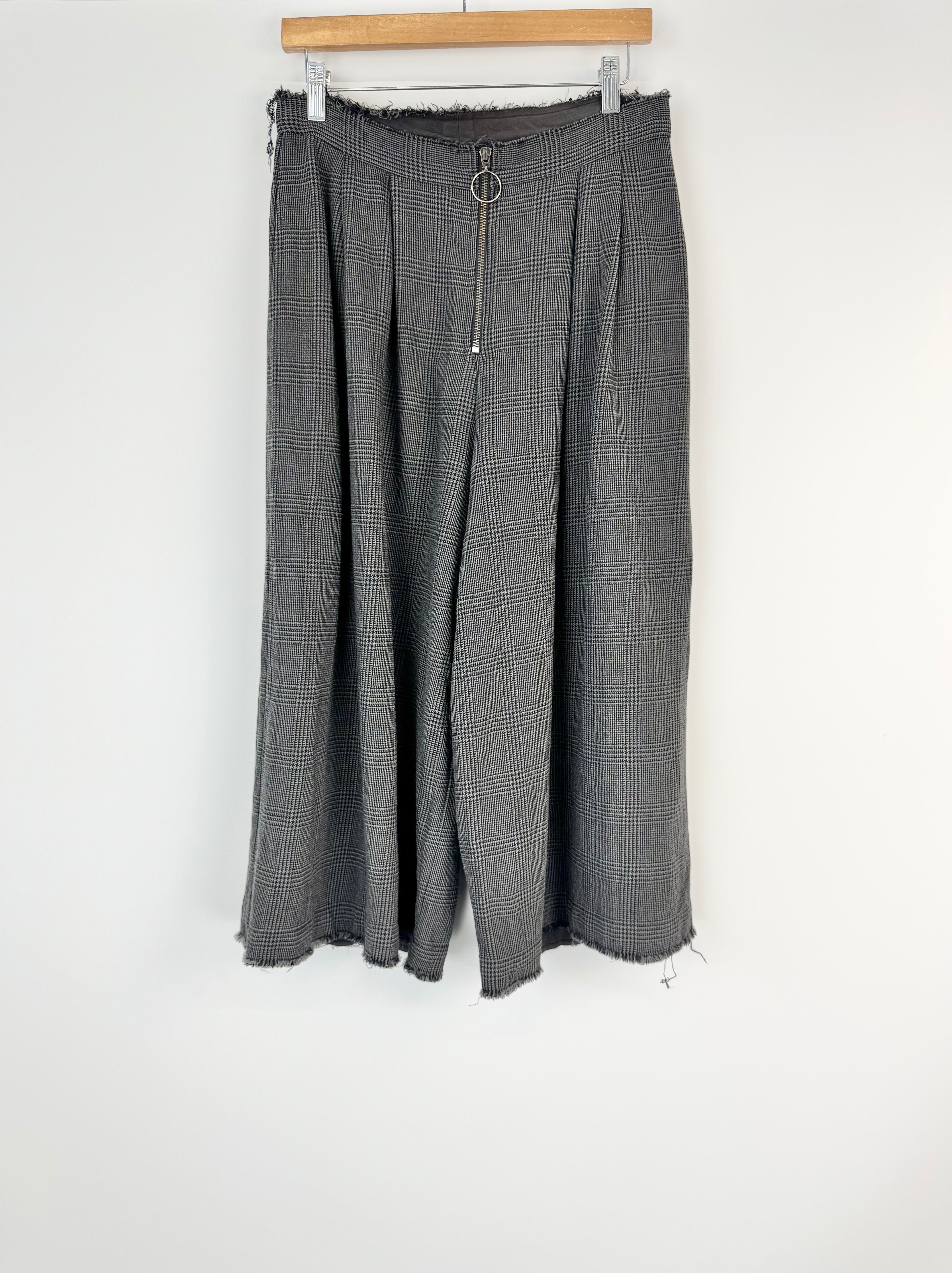 Gray checkered pants on a hanger against a white background