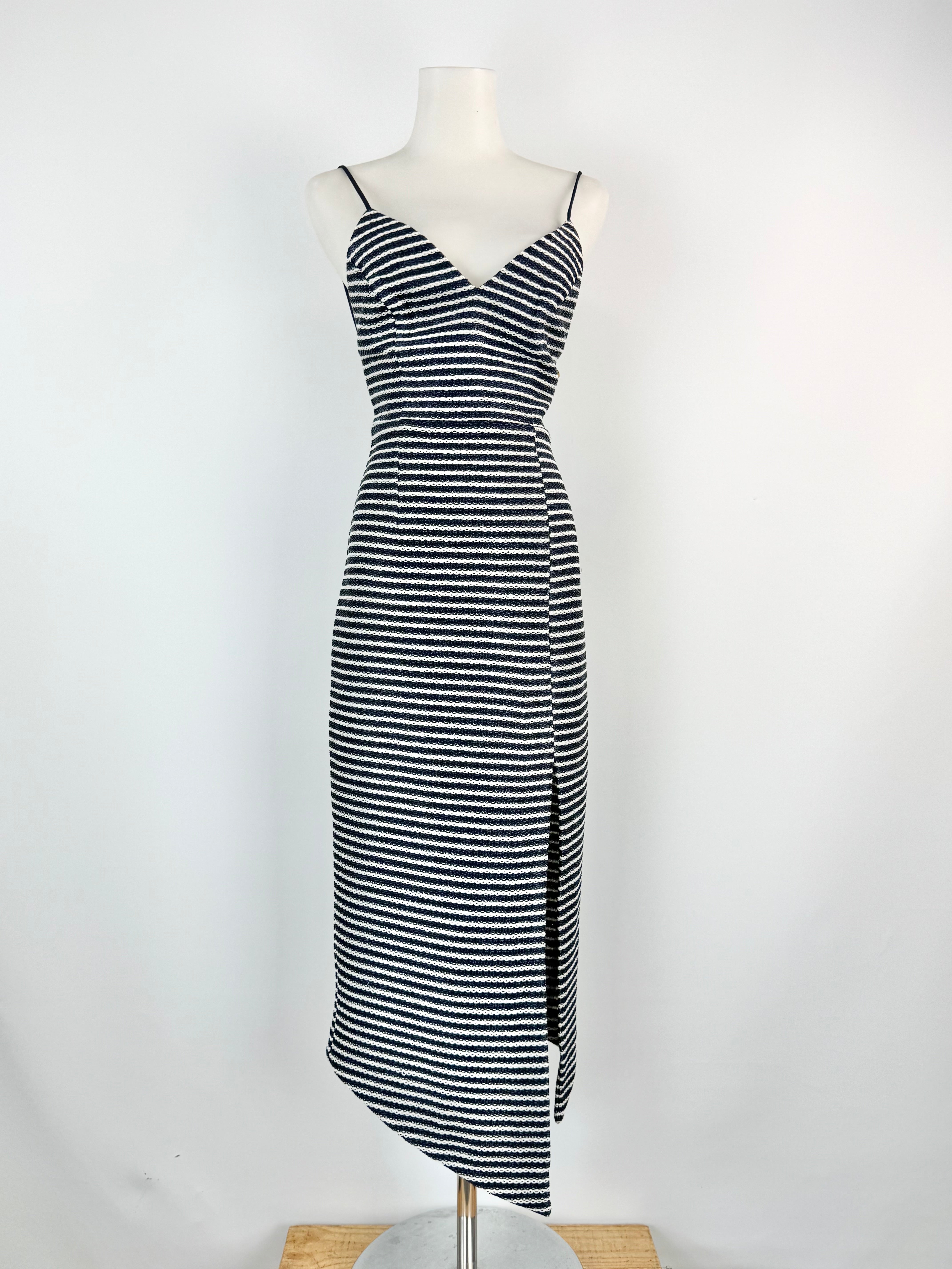 Black and white striped dress on a mannequin against a white background