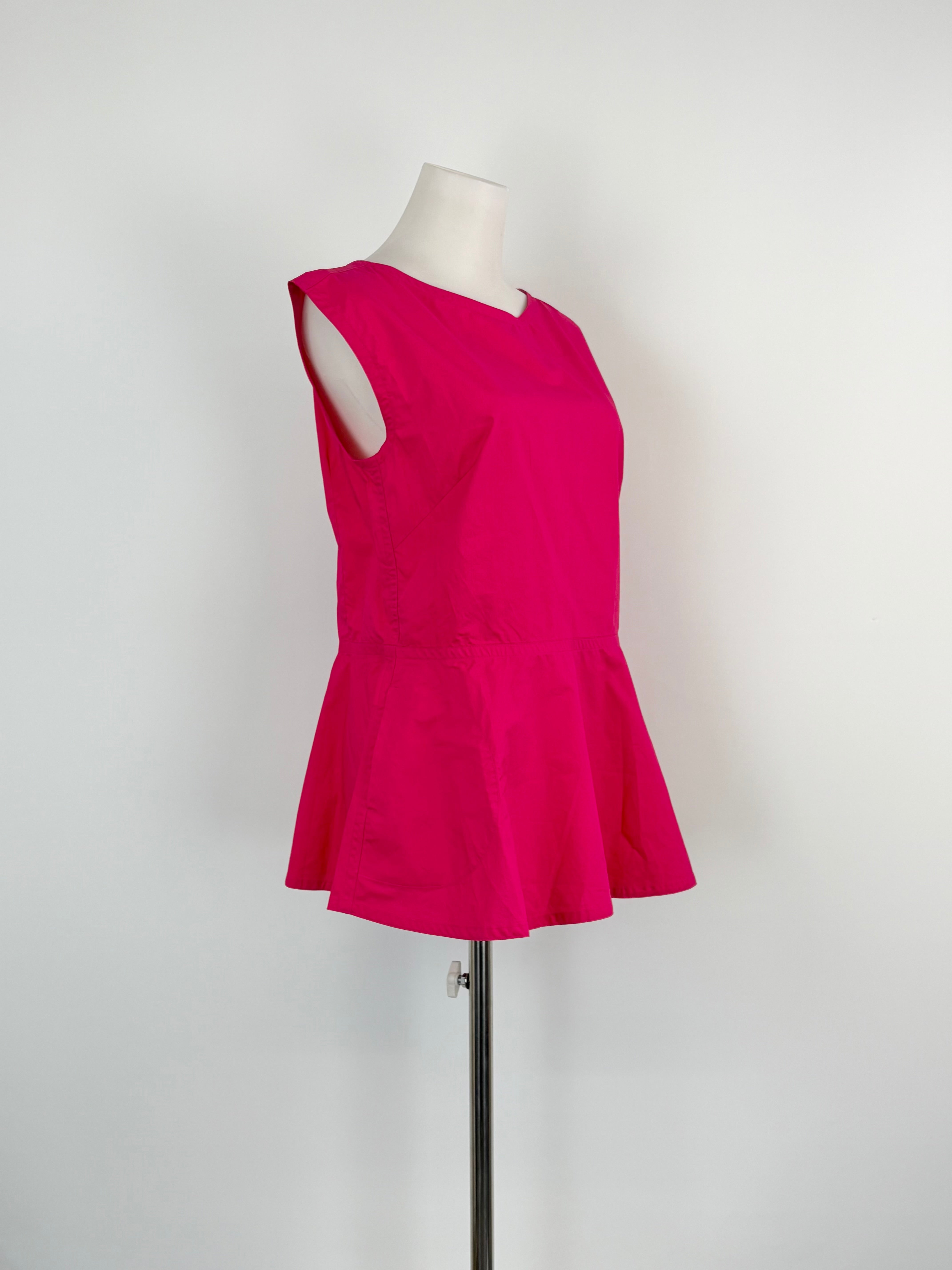 A vibrant raspberry red peplum top on a mannequin against a white background.