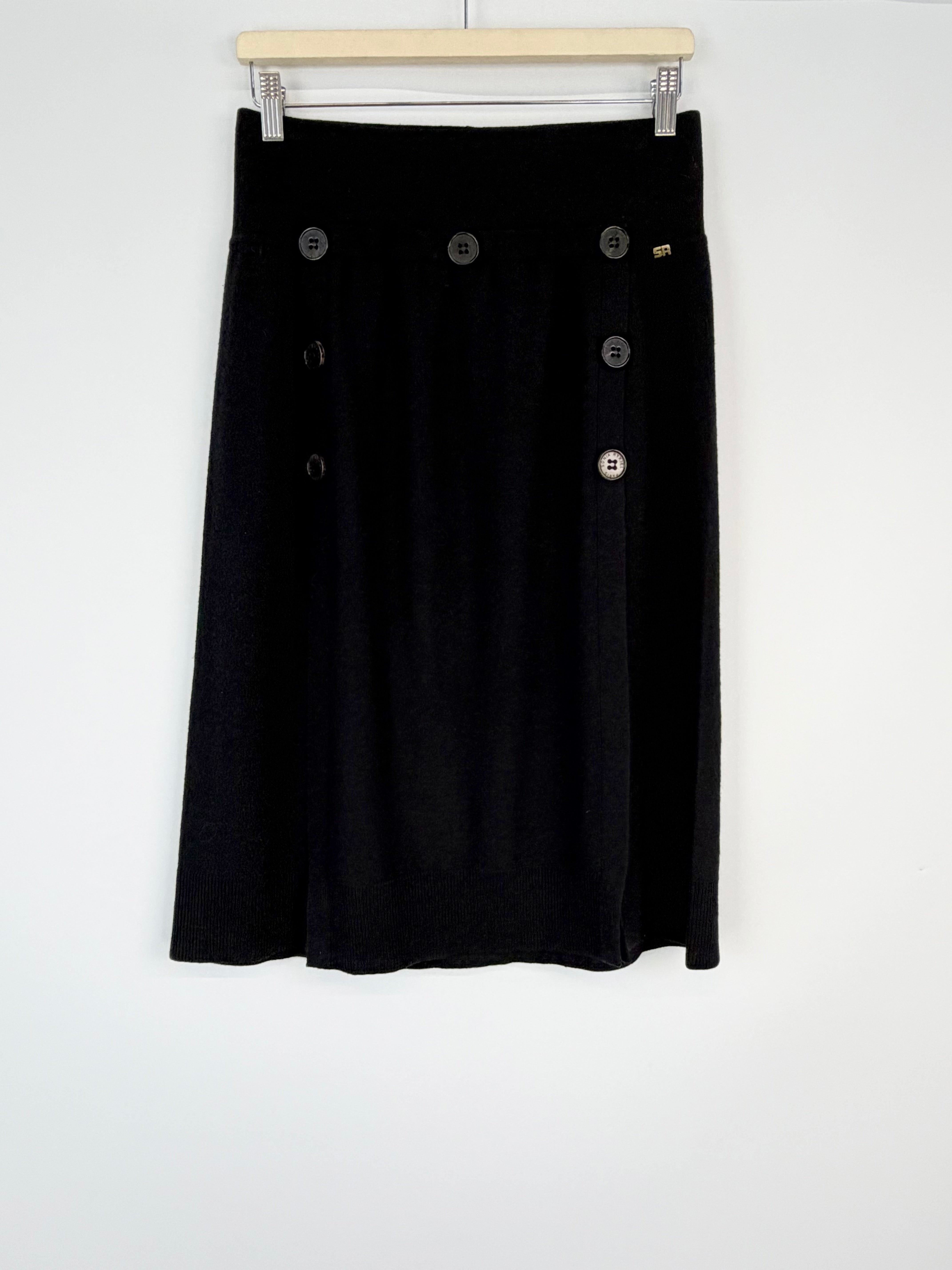 Black skirt with button details on a white background