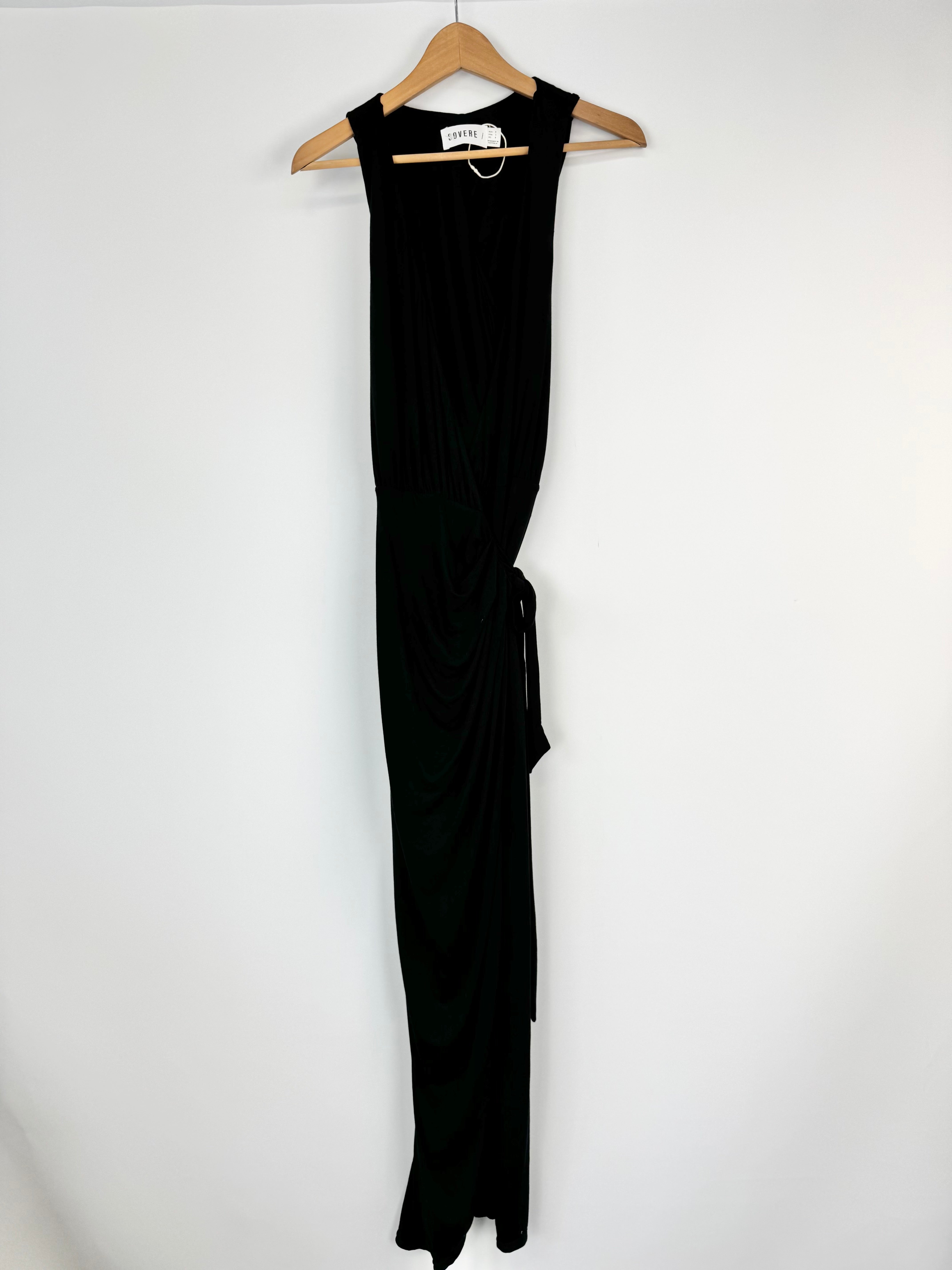 Black sleeveless dress on a hanger against a white background