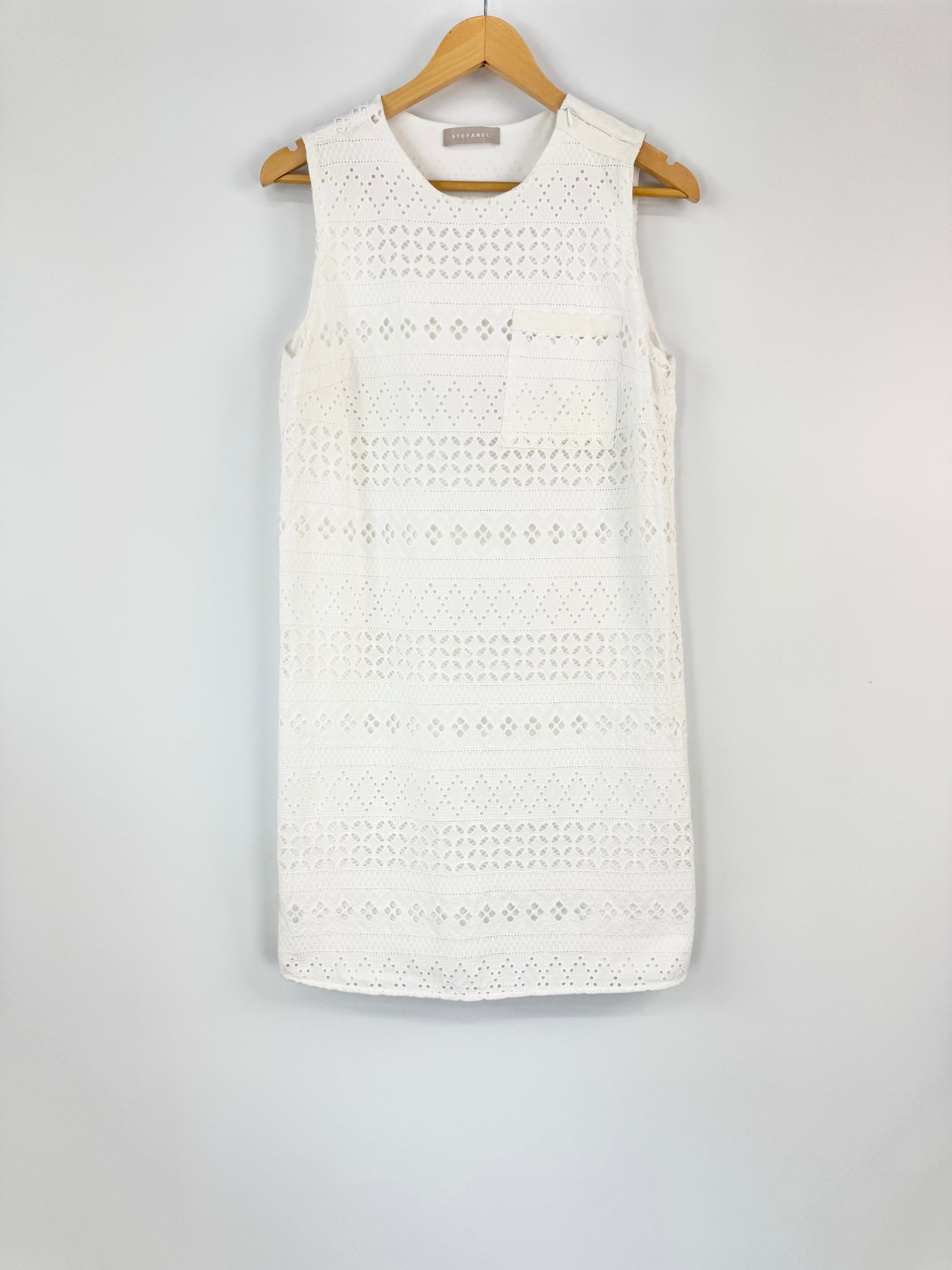 White lace dress on a hanger against a white background