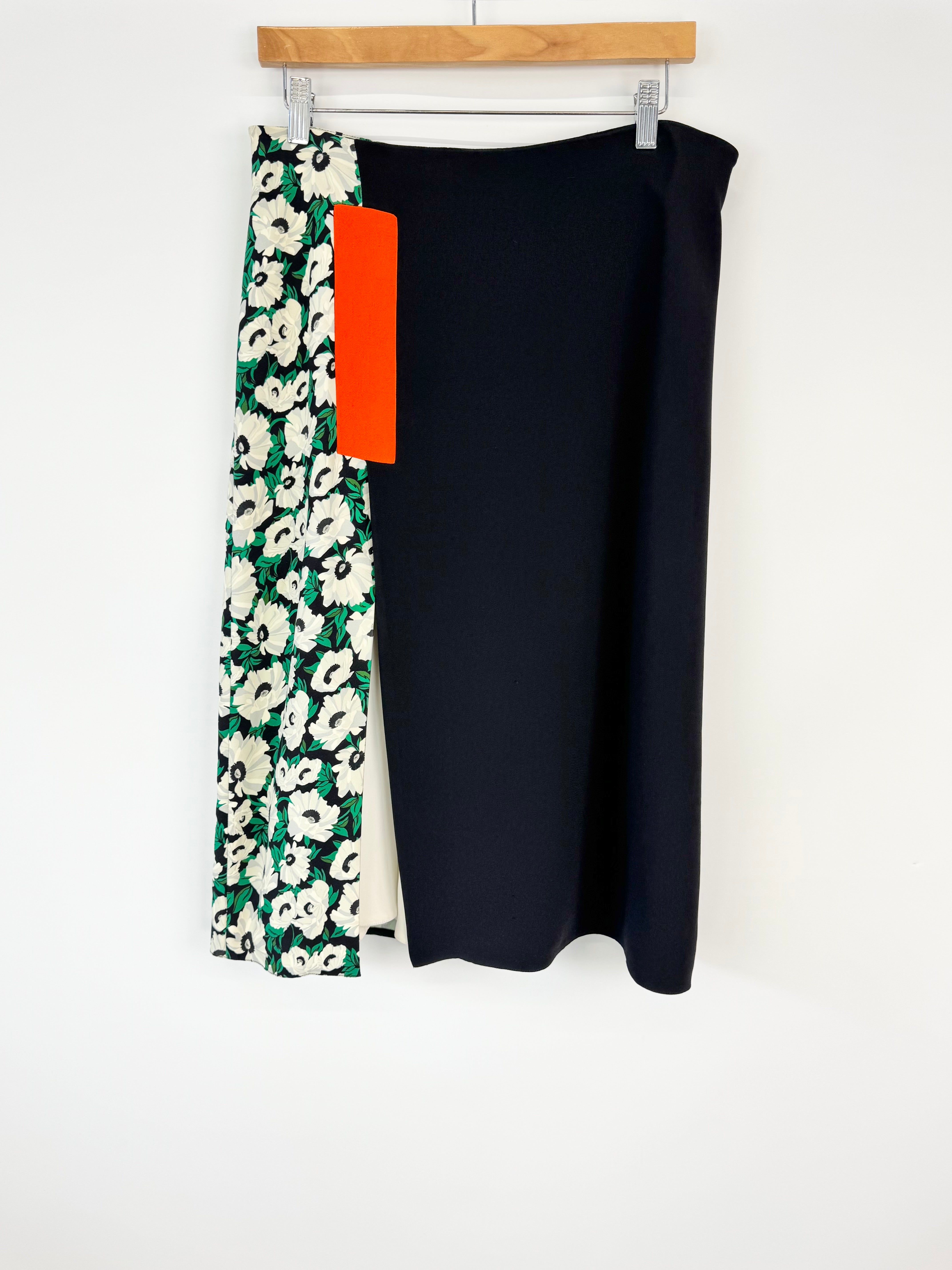 Black skirt with floral patterned tag on a white background