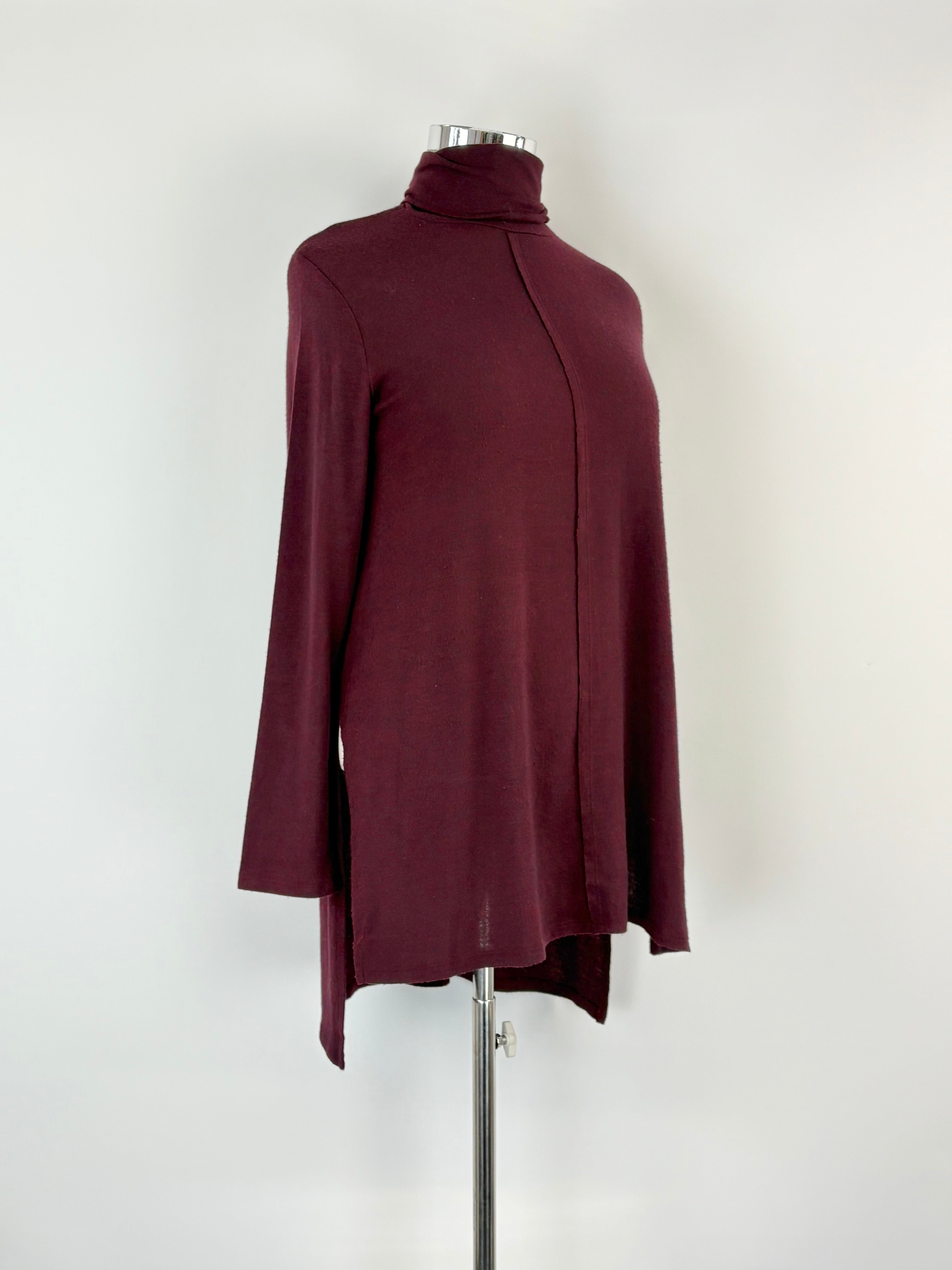 Maroon turtleneck sweater on a mannequin against a white background