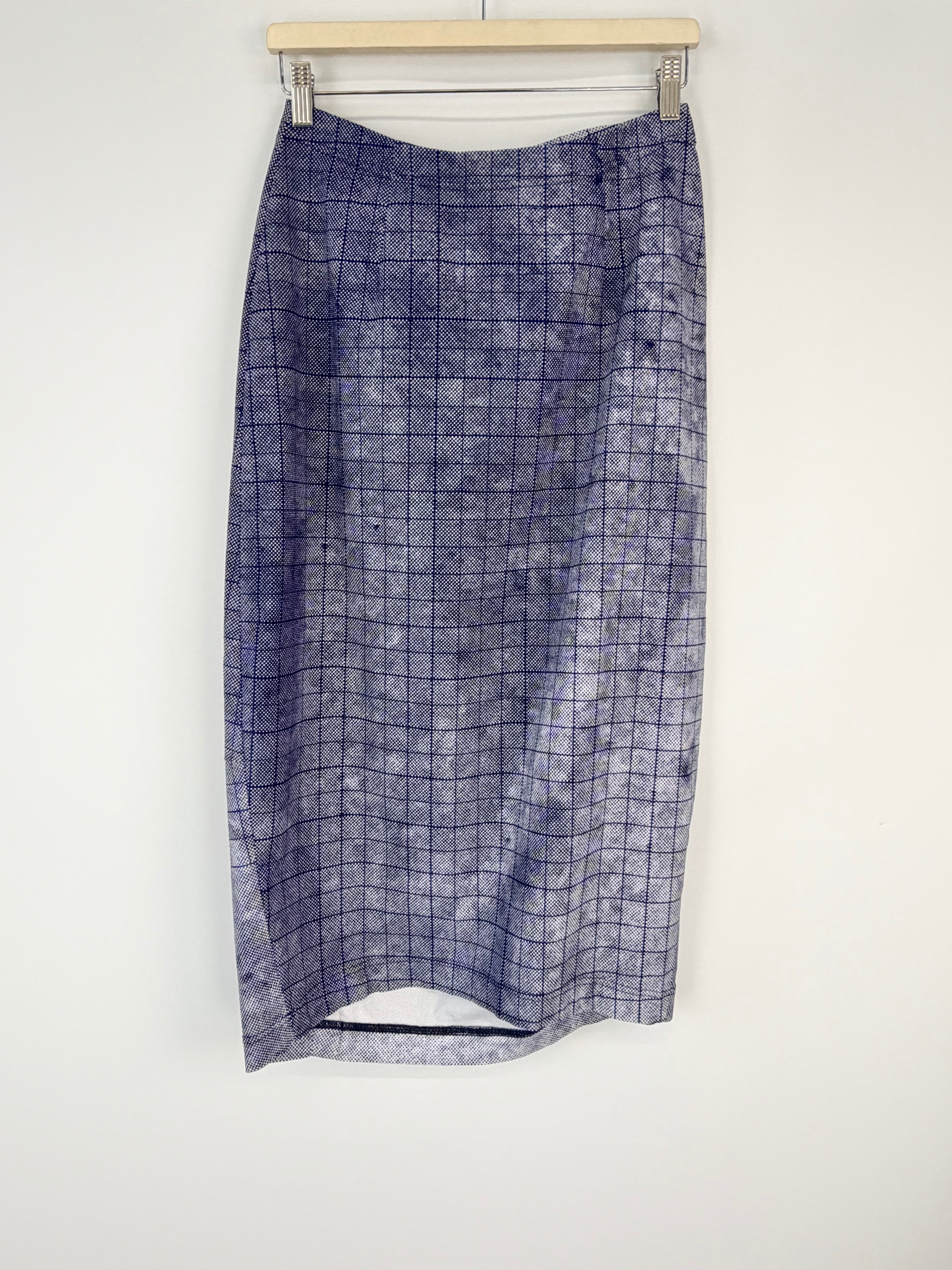 Blue checkered skirt on a hanger against a white background