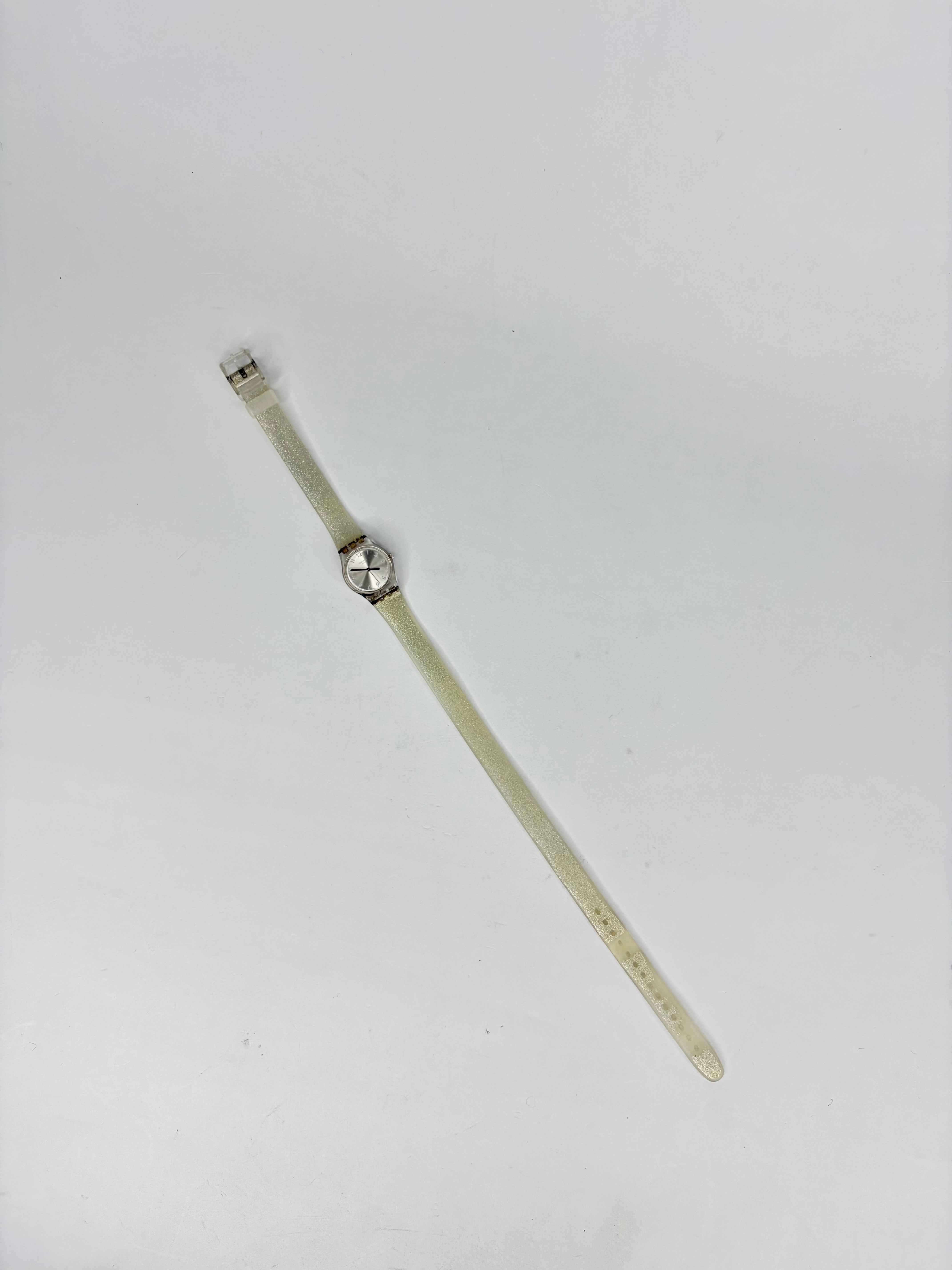 Beige wristband with a metal clasp on a white background