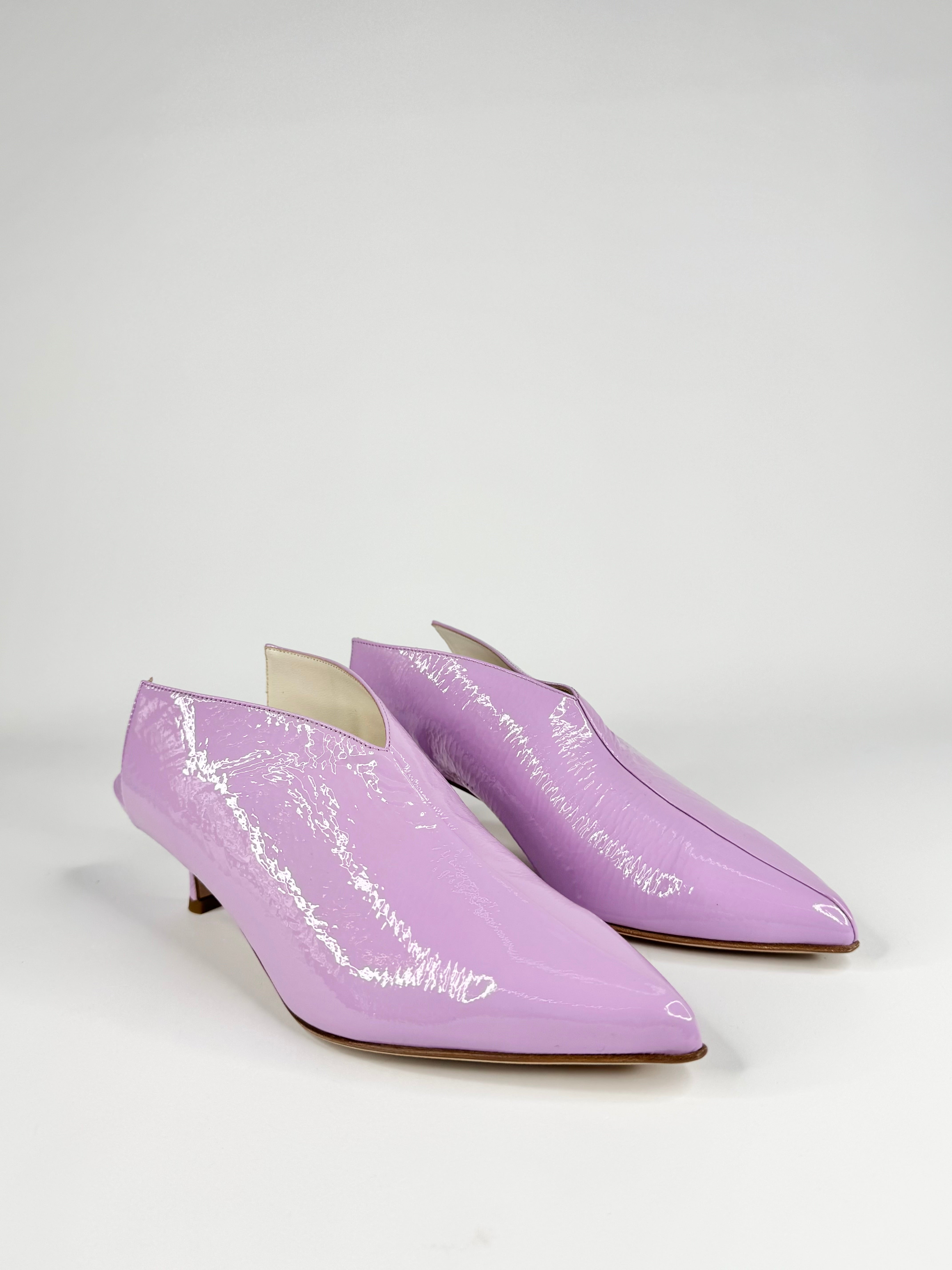 Pair of lavender high-heeled shoes on a white background