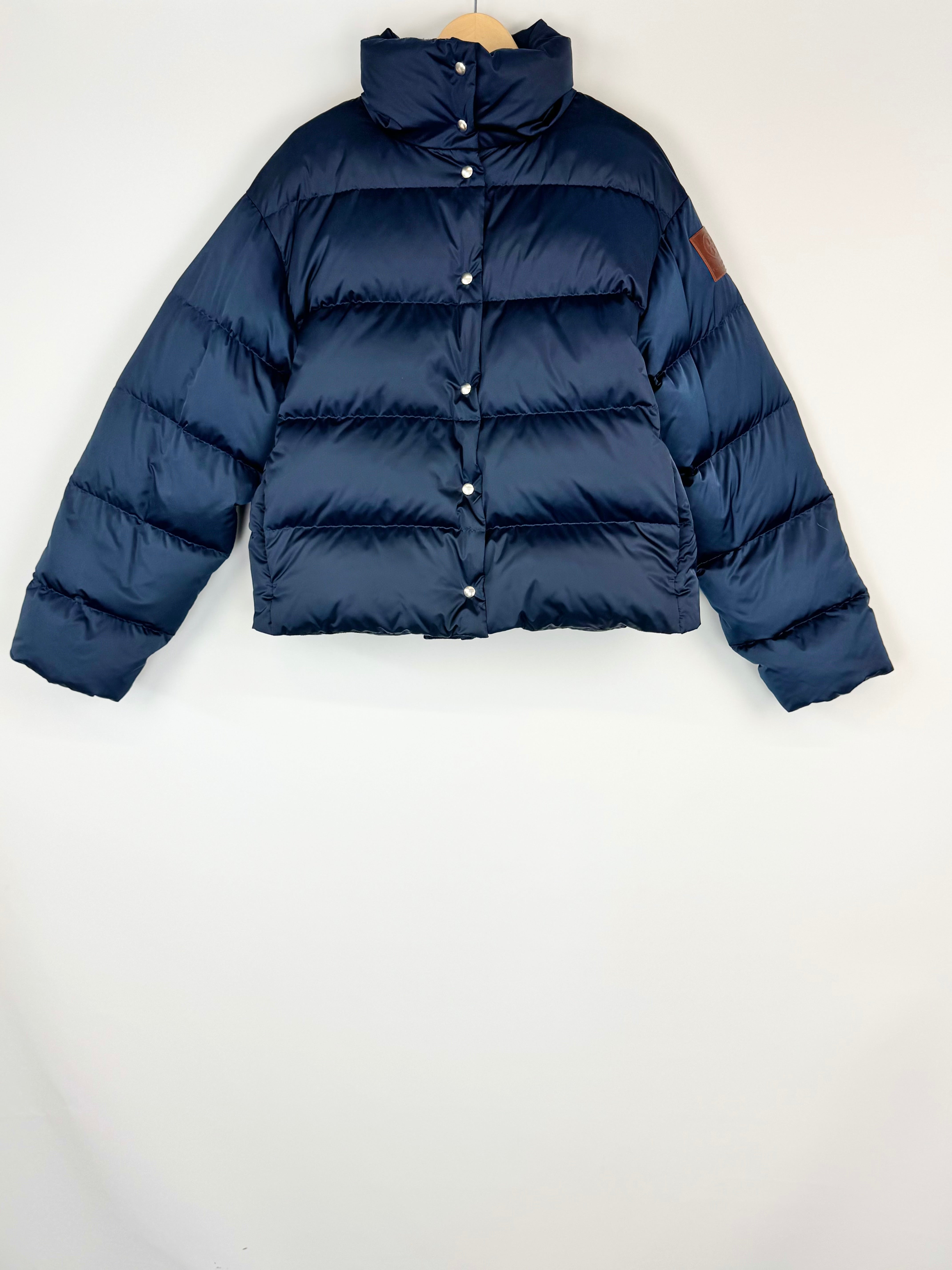 Navy blue puffer jacket on a white background