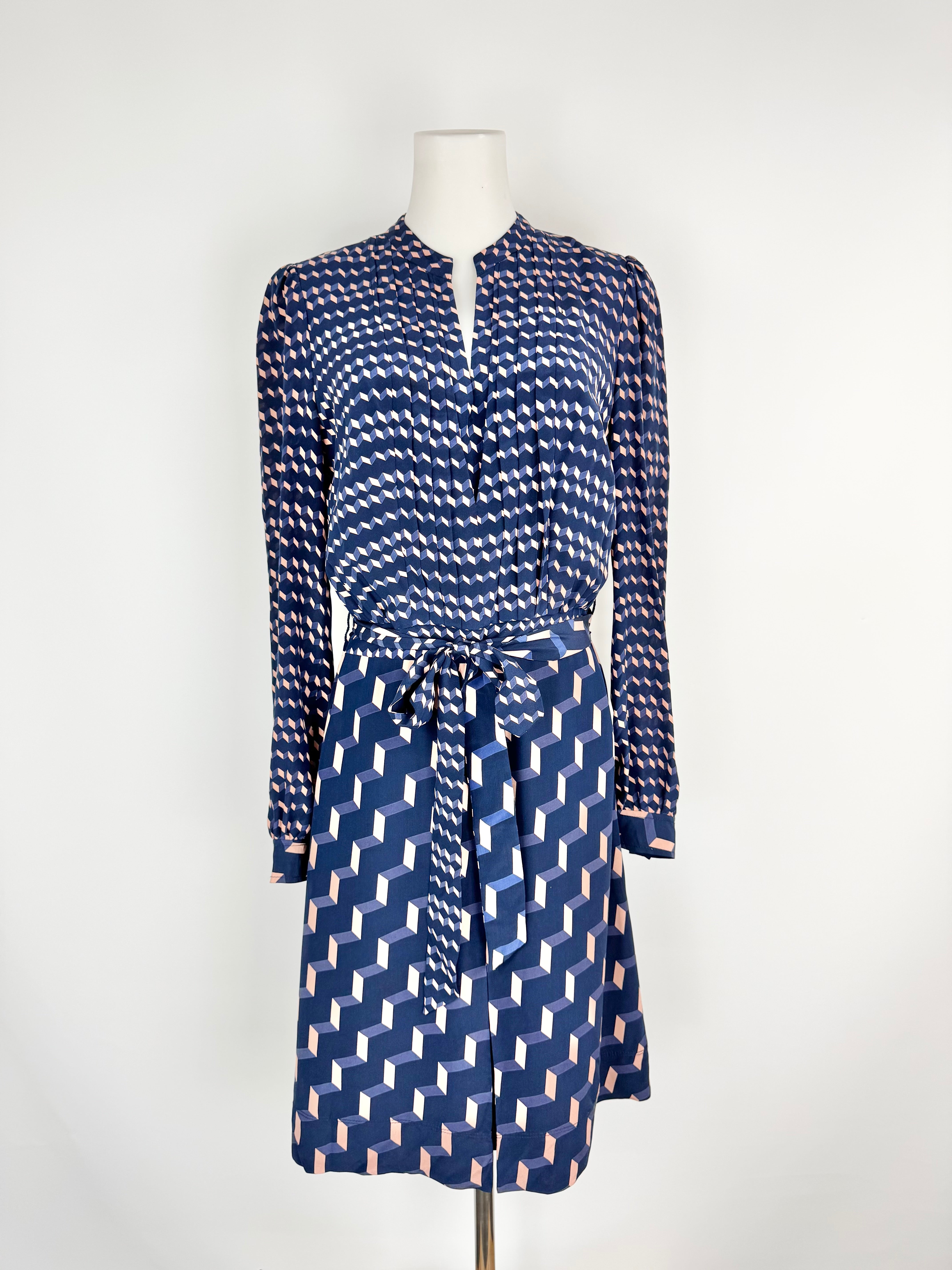 Blue patterned dress on a mannequin against a white background