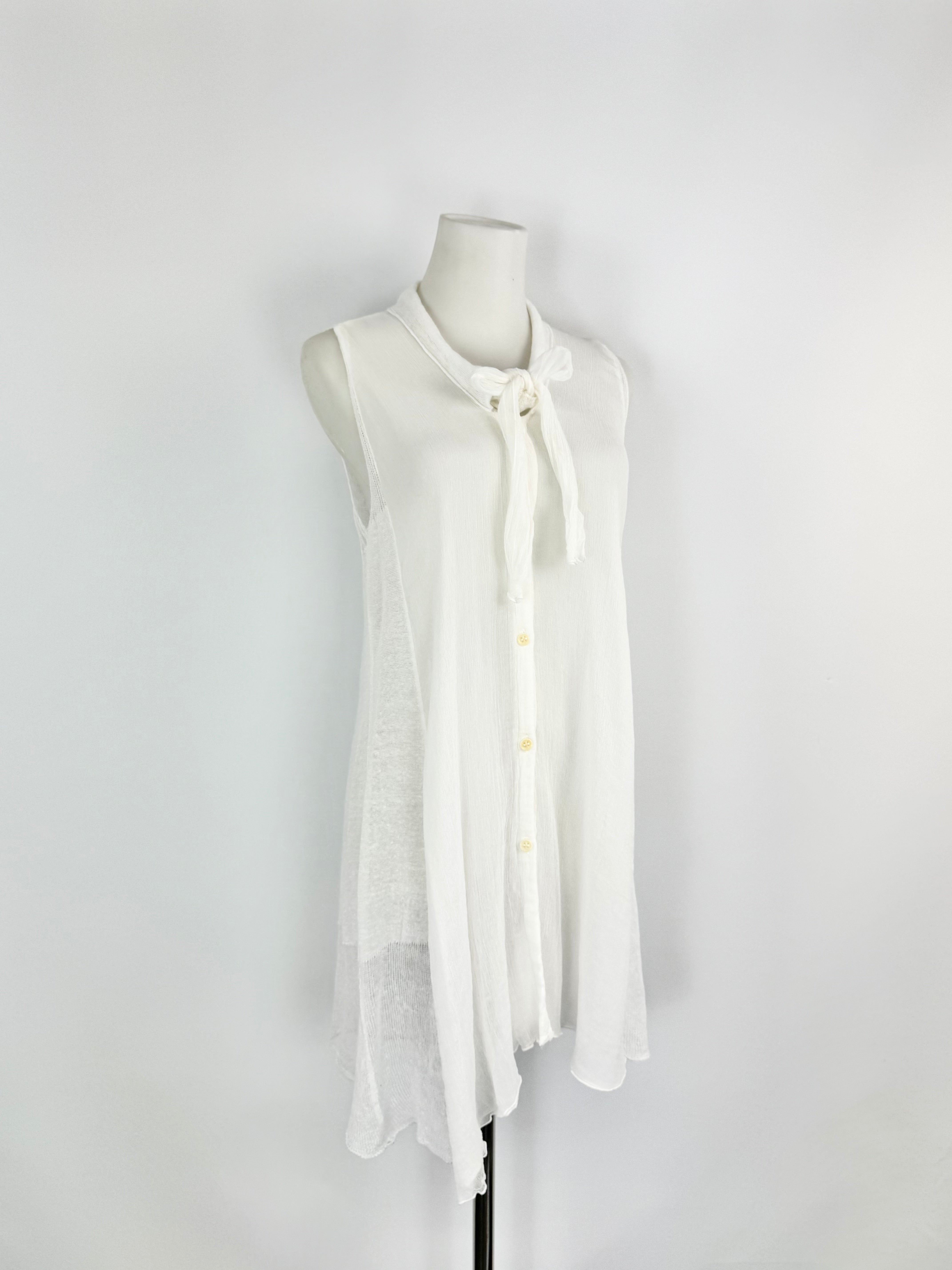 White sleeveless blouse on a mannequin against a white background