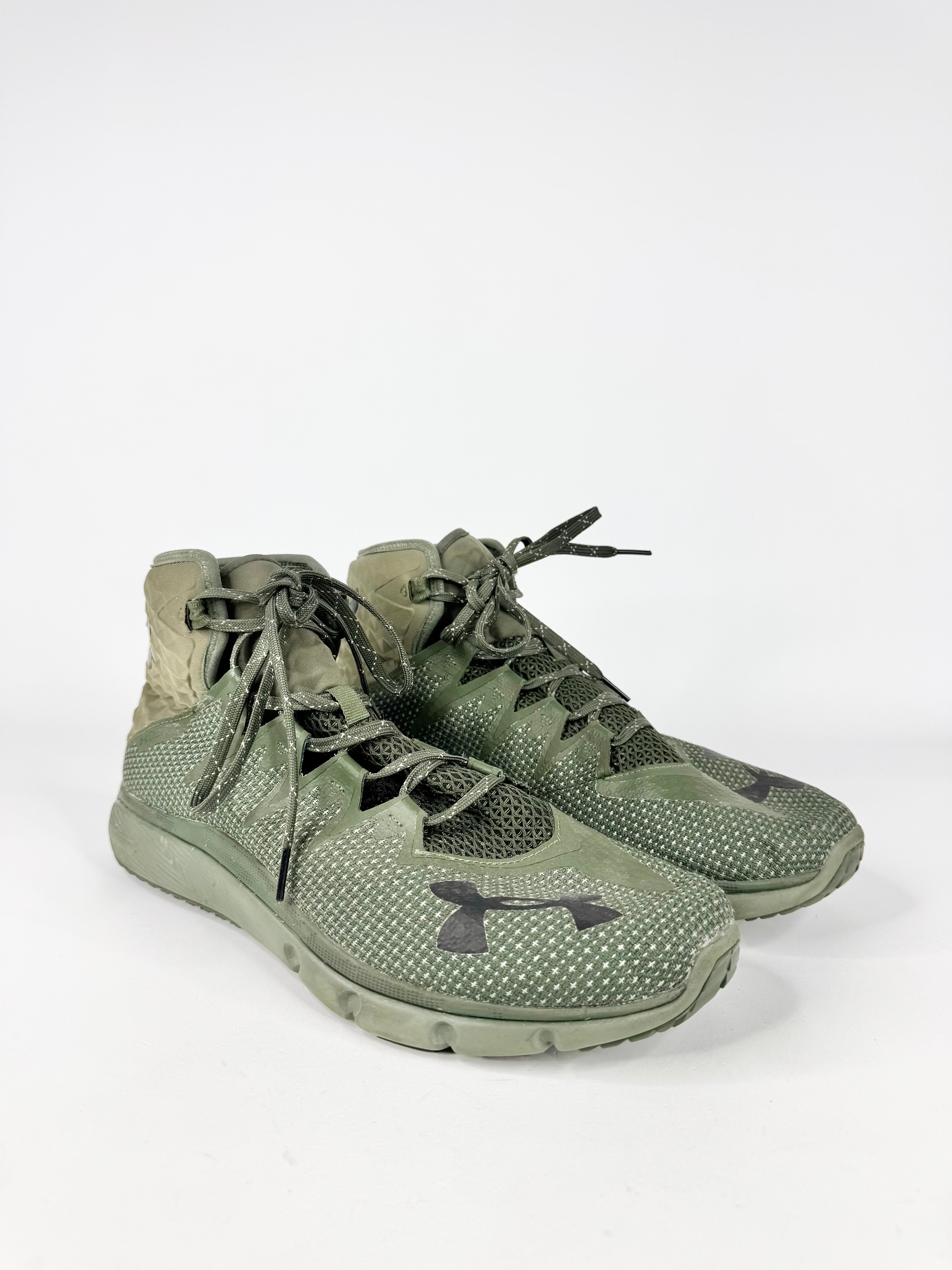 Green athletic shoes with Under Armour logo on a white background