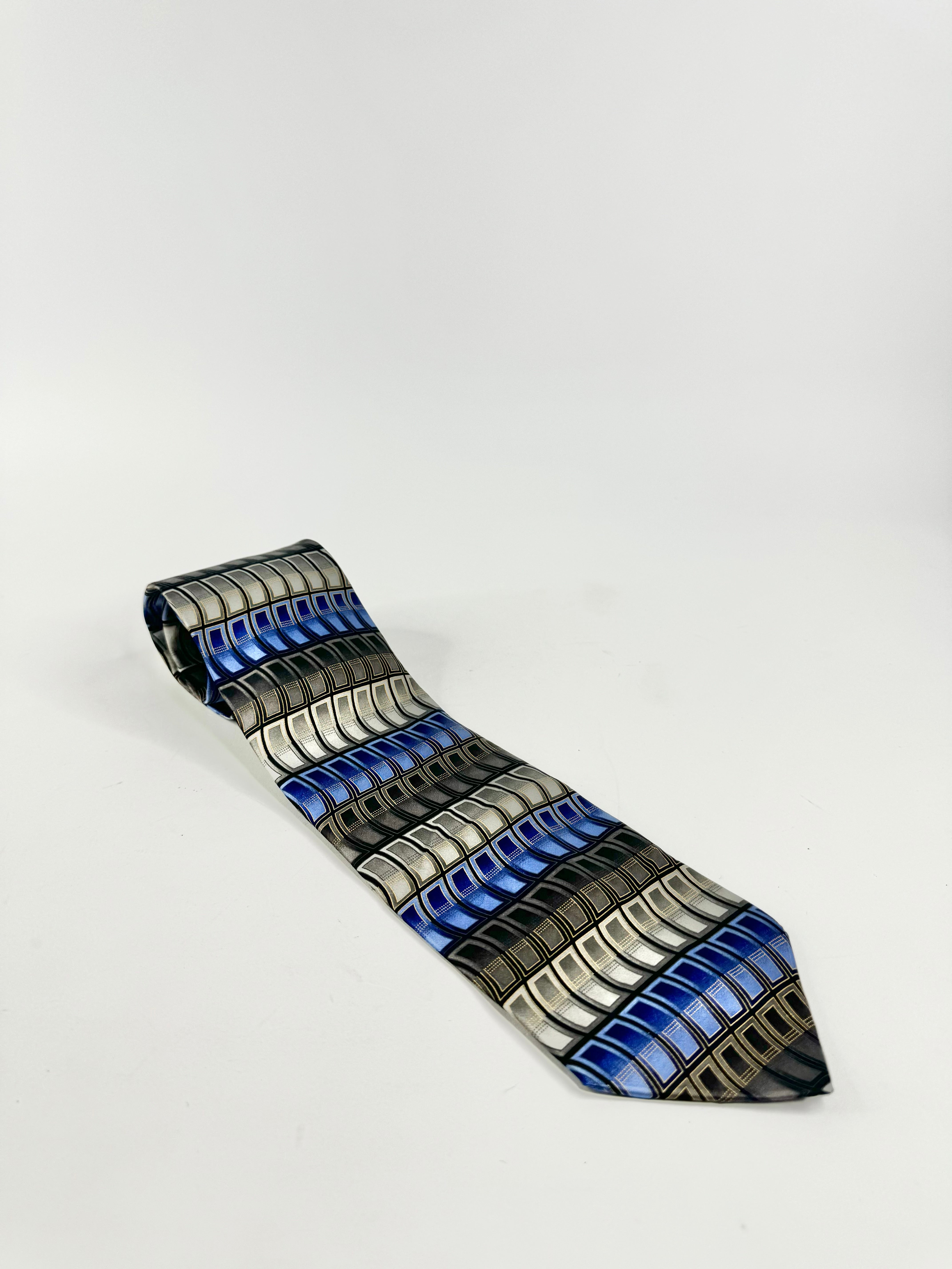 A silk tie with blue and grey stripes laid out on a white background.