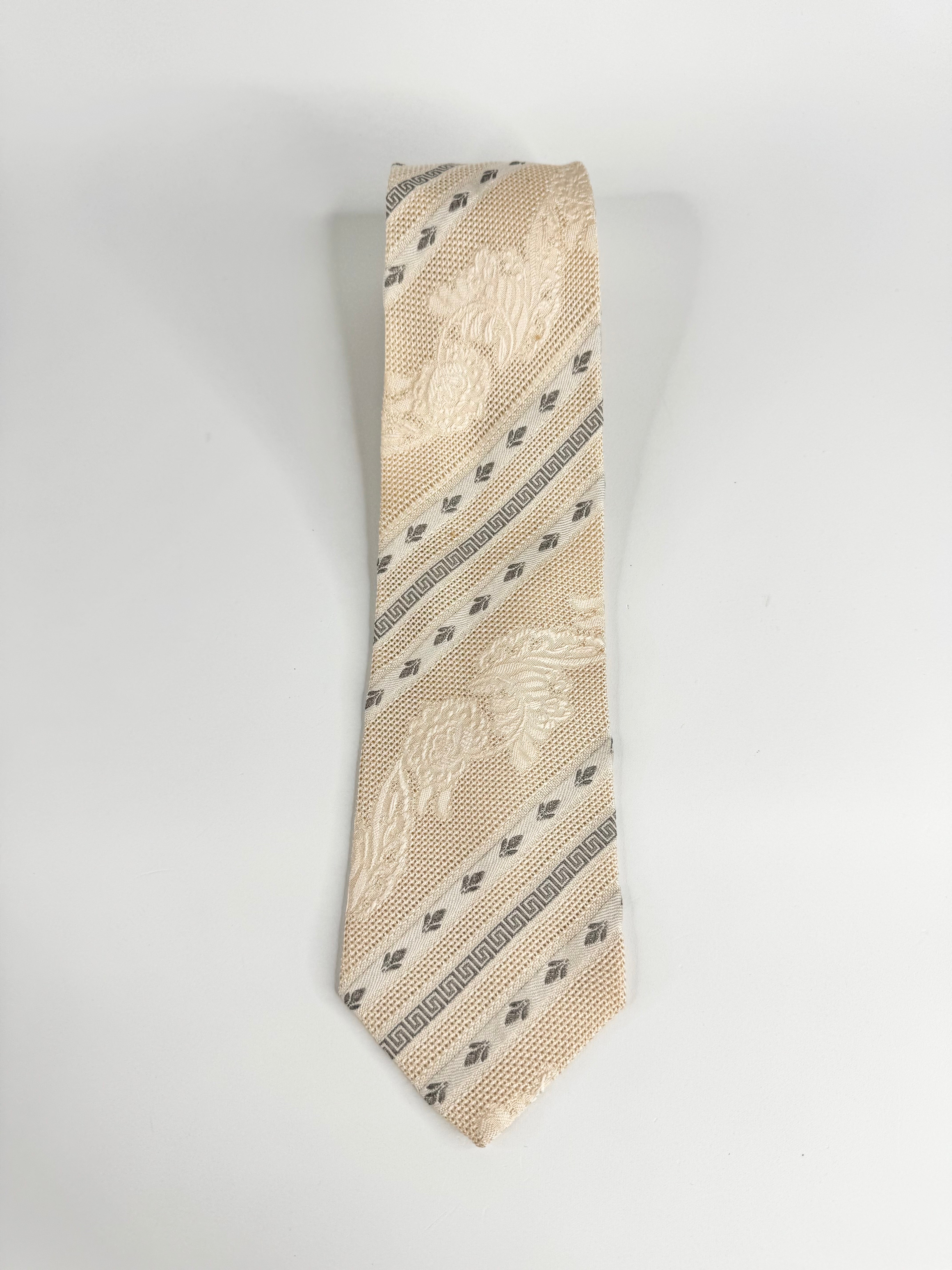 Beige patterned tie on a white background