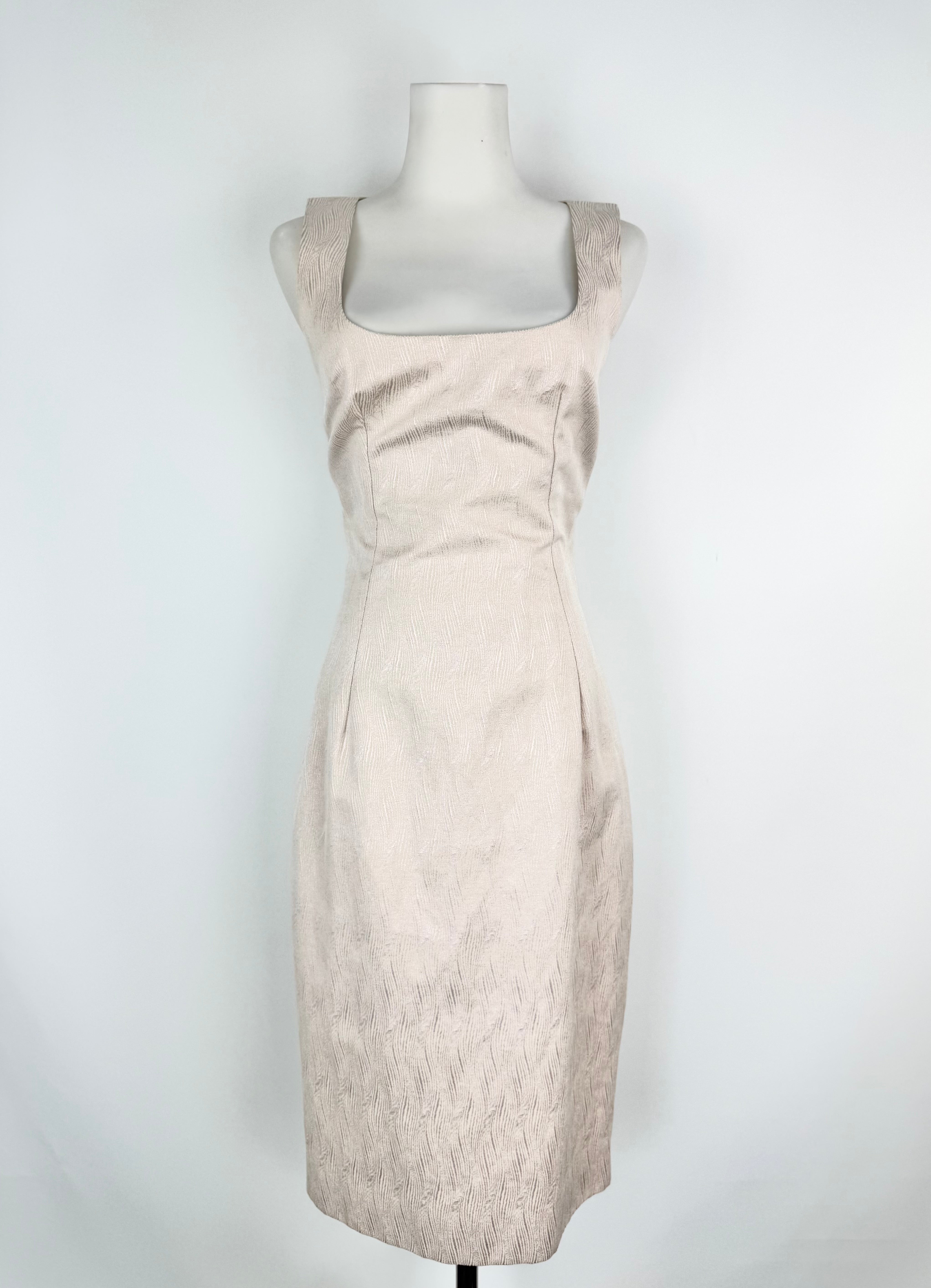 Soft pink dress on a mannequin against a white background