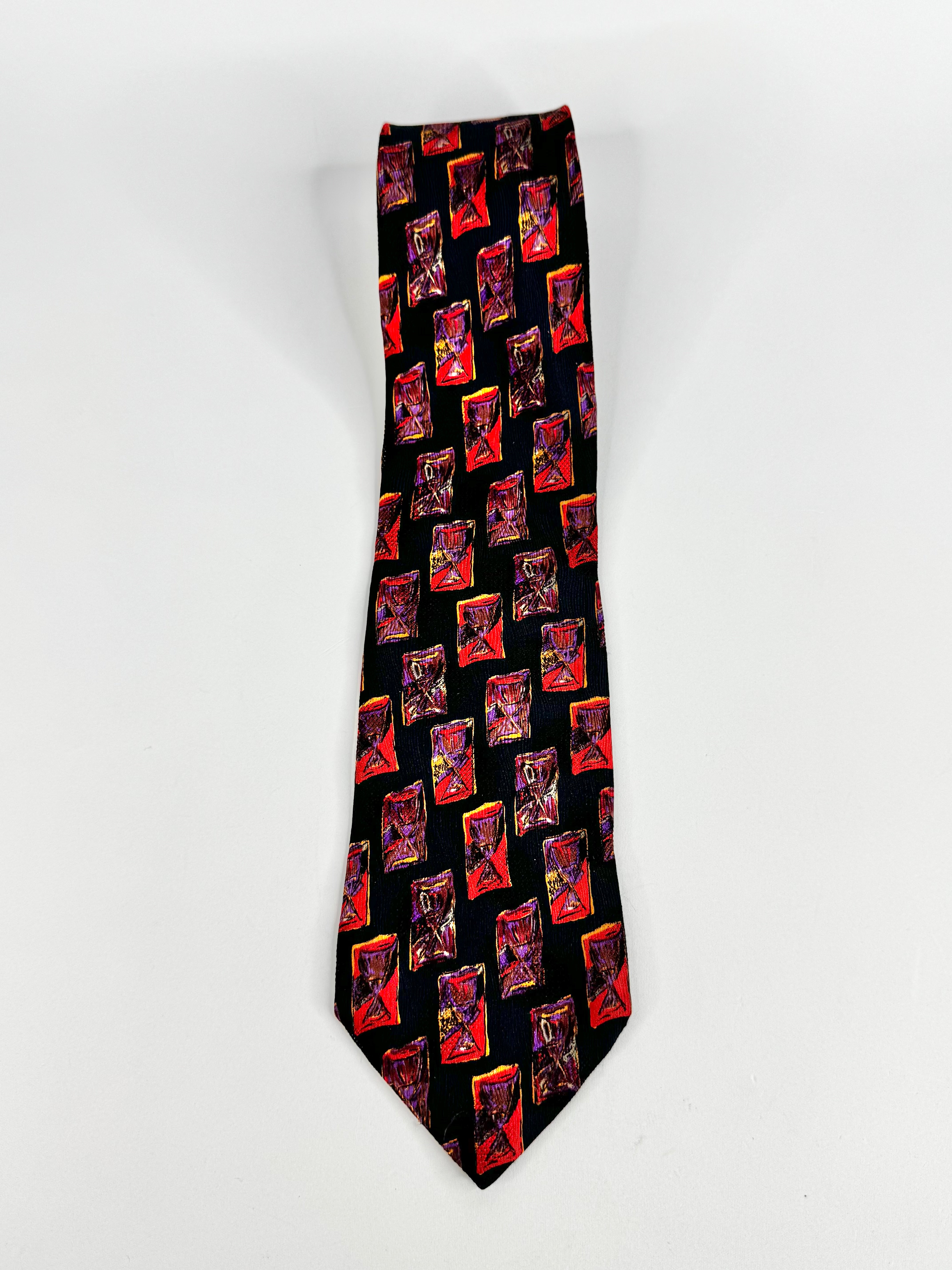 Black tie with red and orange geometric pattern on a white background