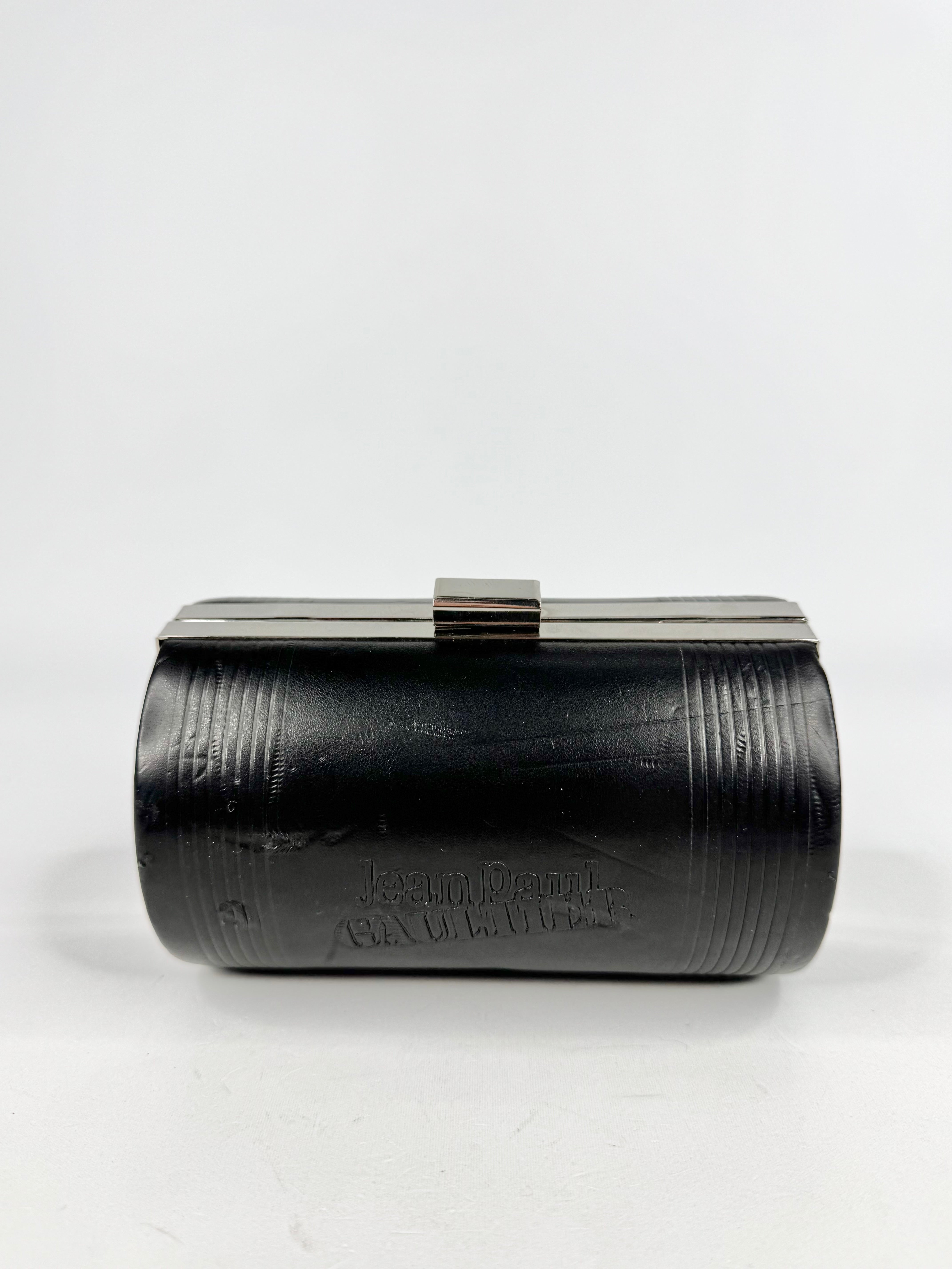 Black cylindrical object with text on a white background