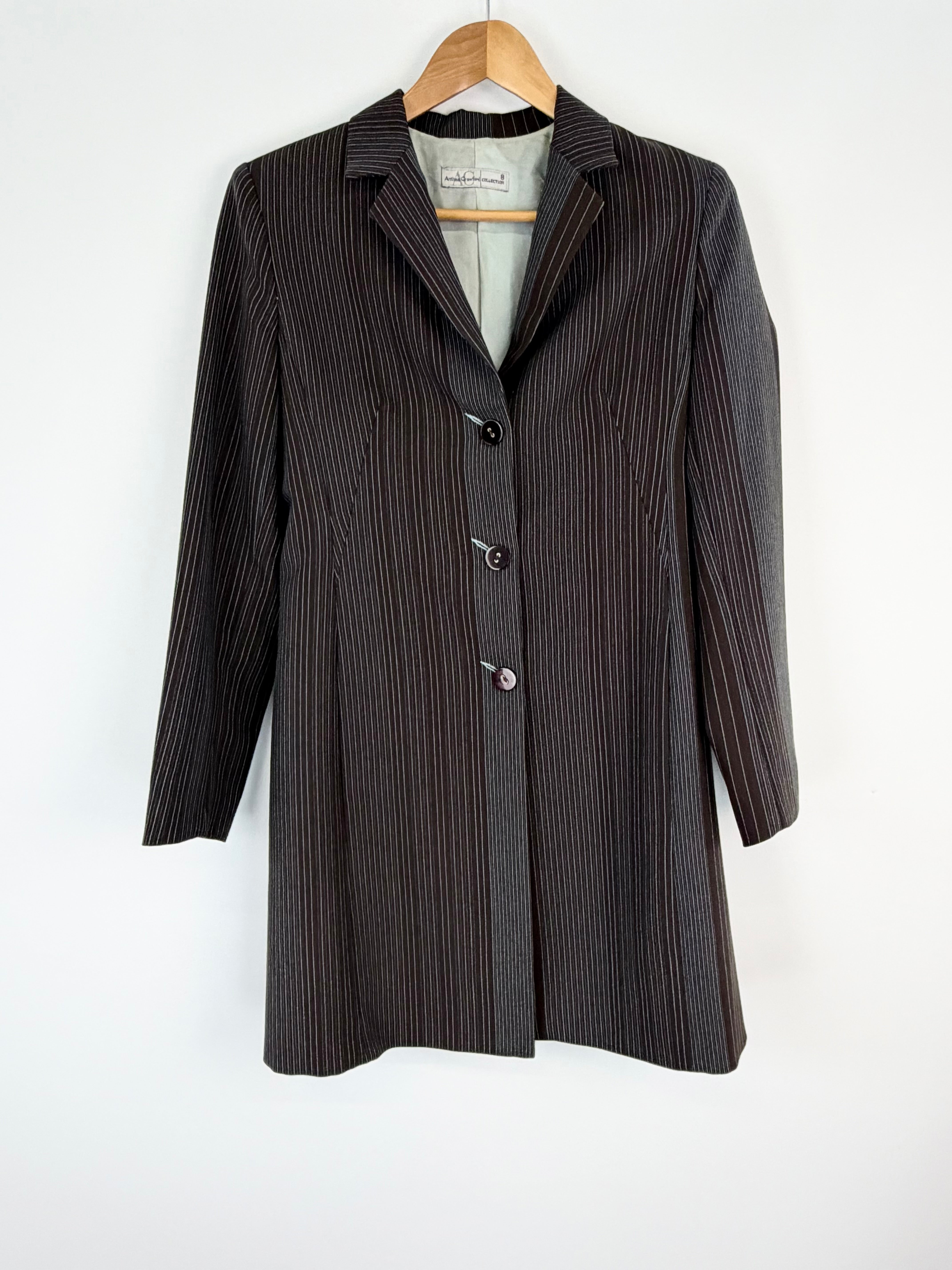 Pinstripe coat on a hanger against a white background