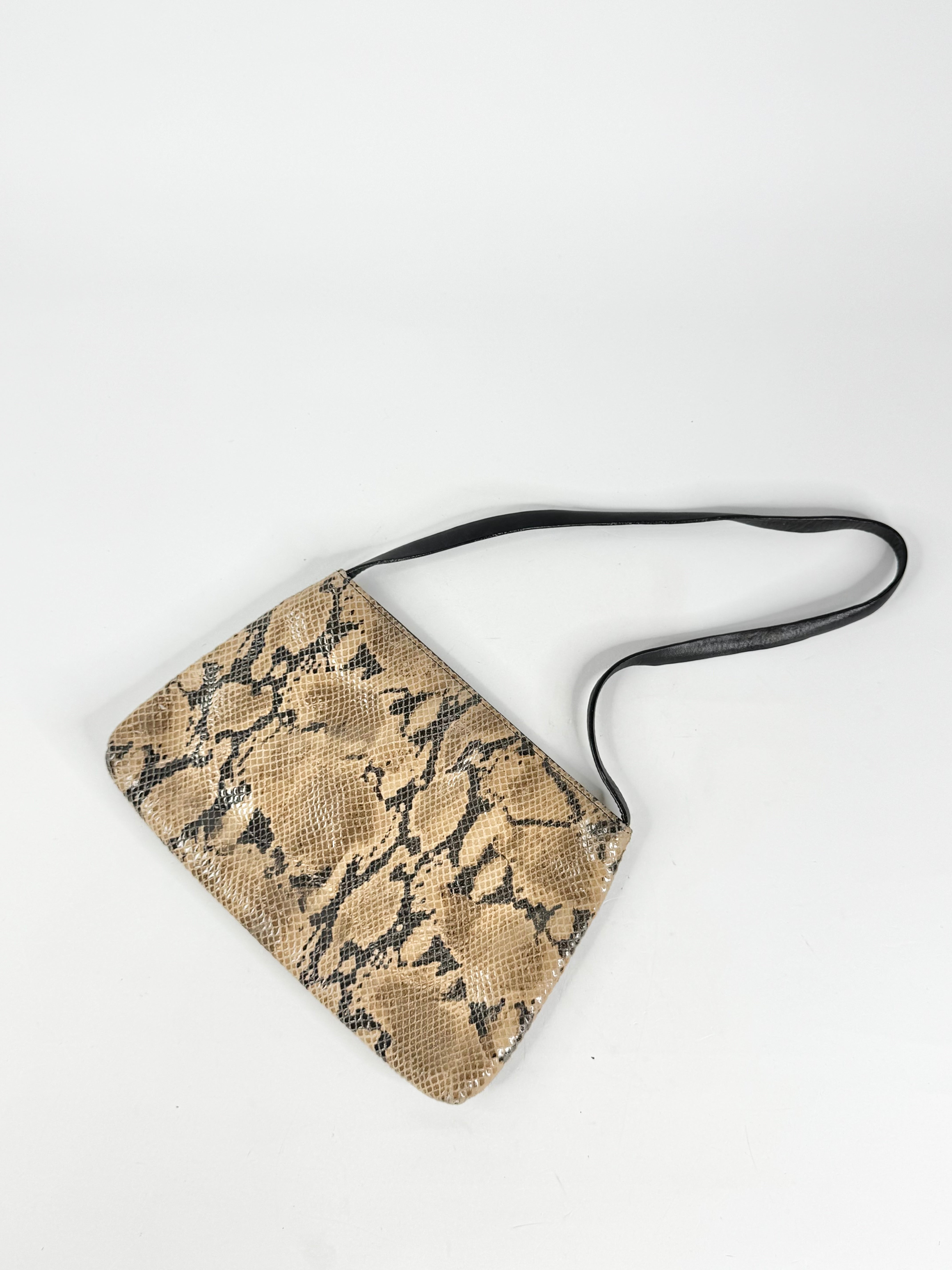 Snake print crossbody bag on a white background
