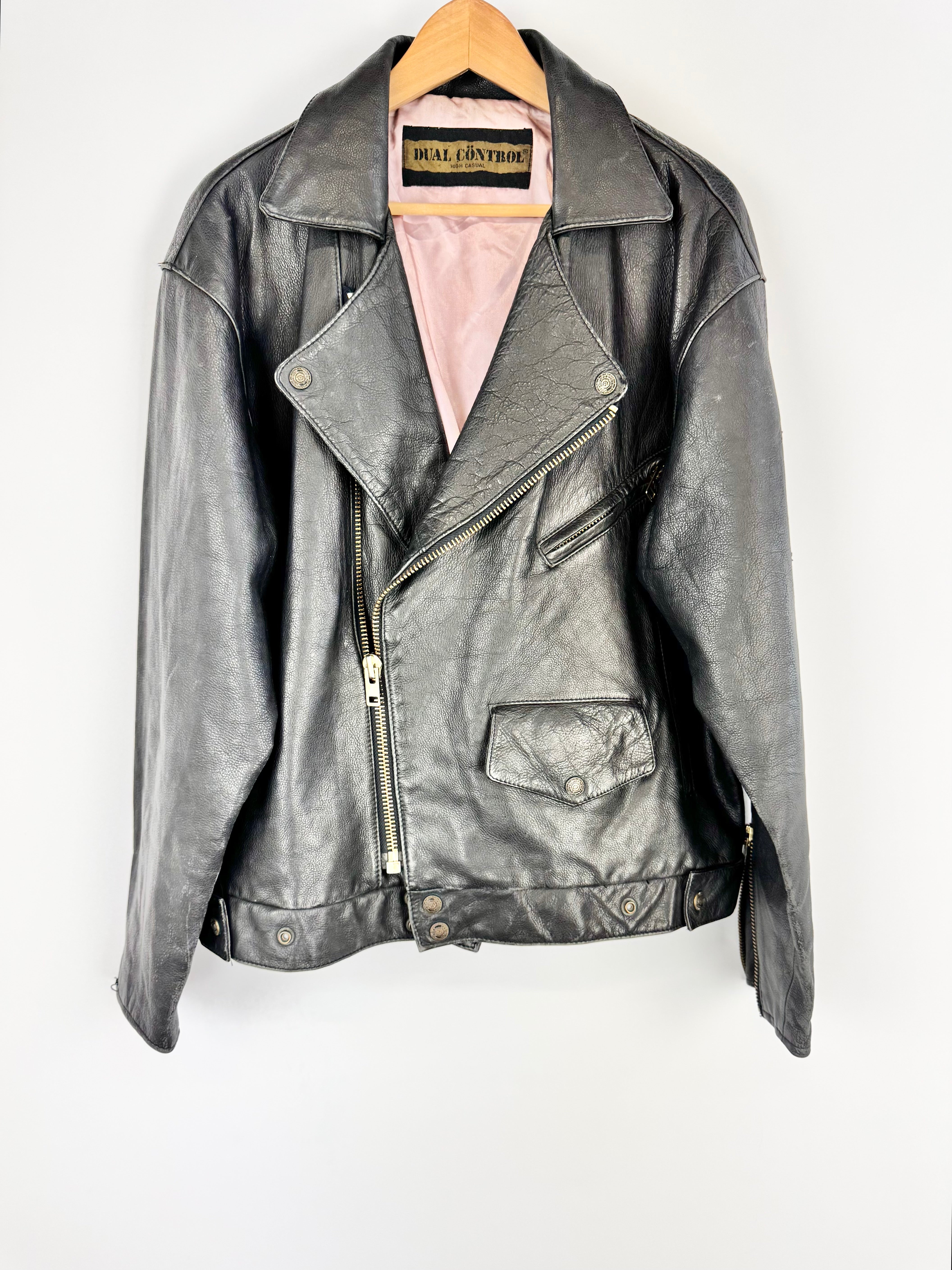 Gray leather jacket on a hanger against a white background