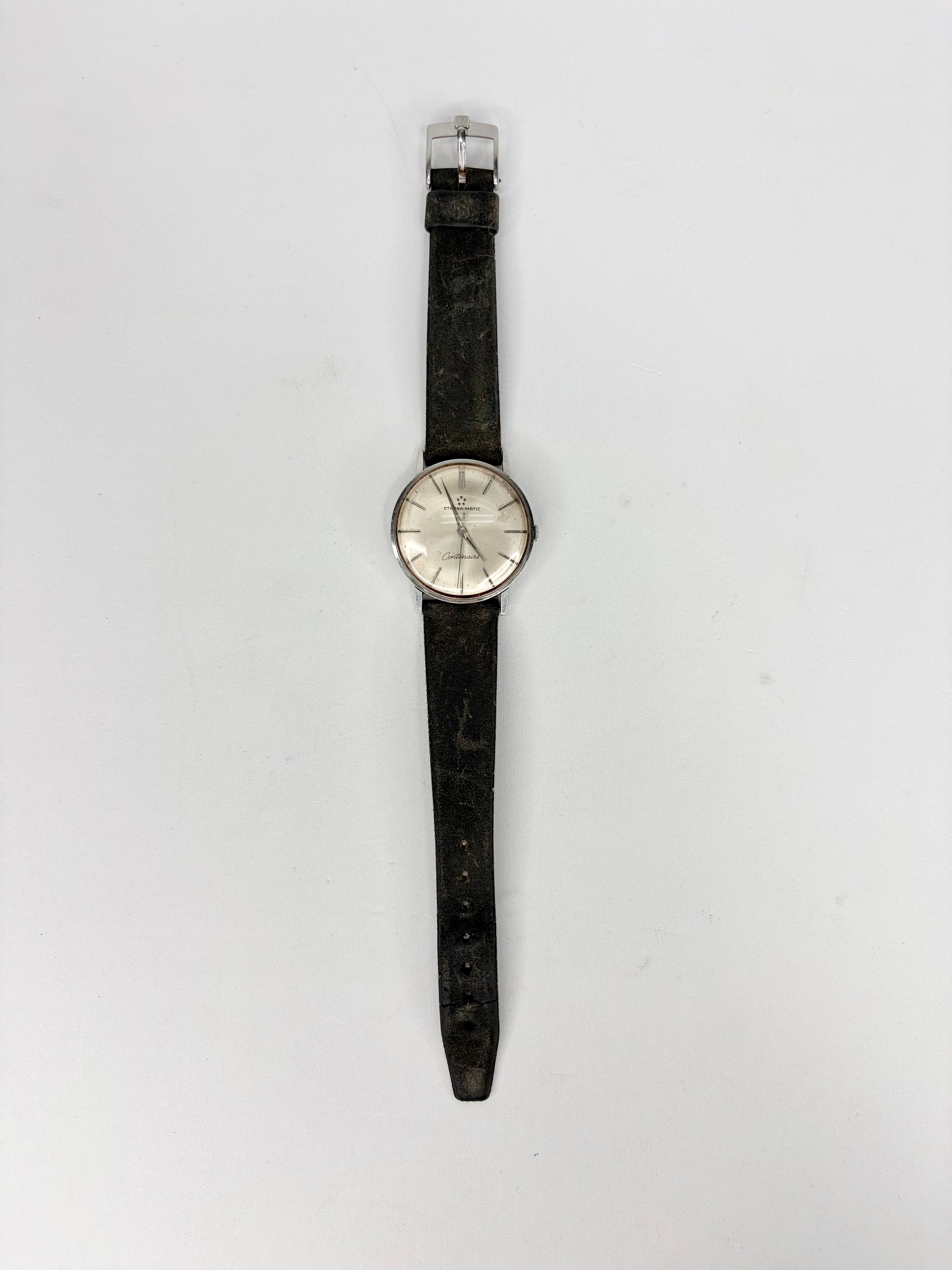 Wristwatch with black strap on a white background
