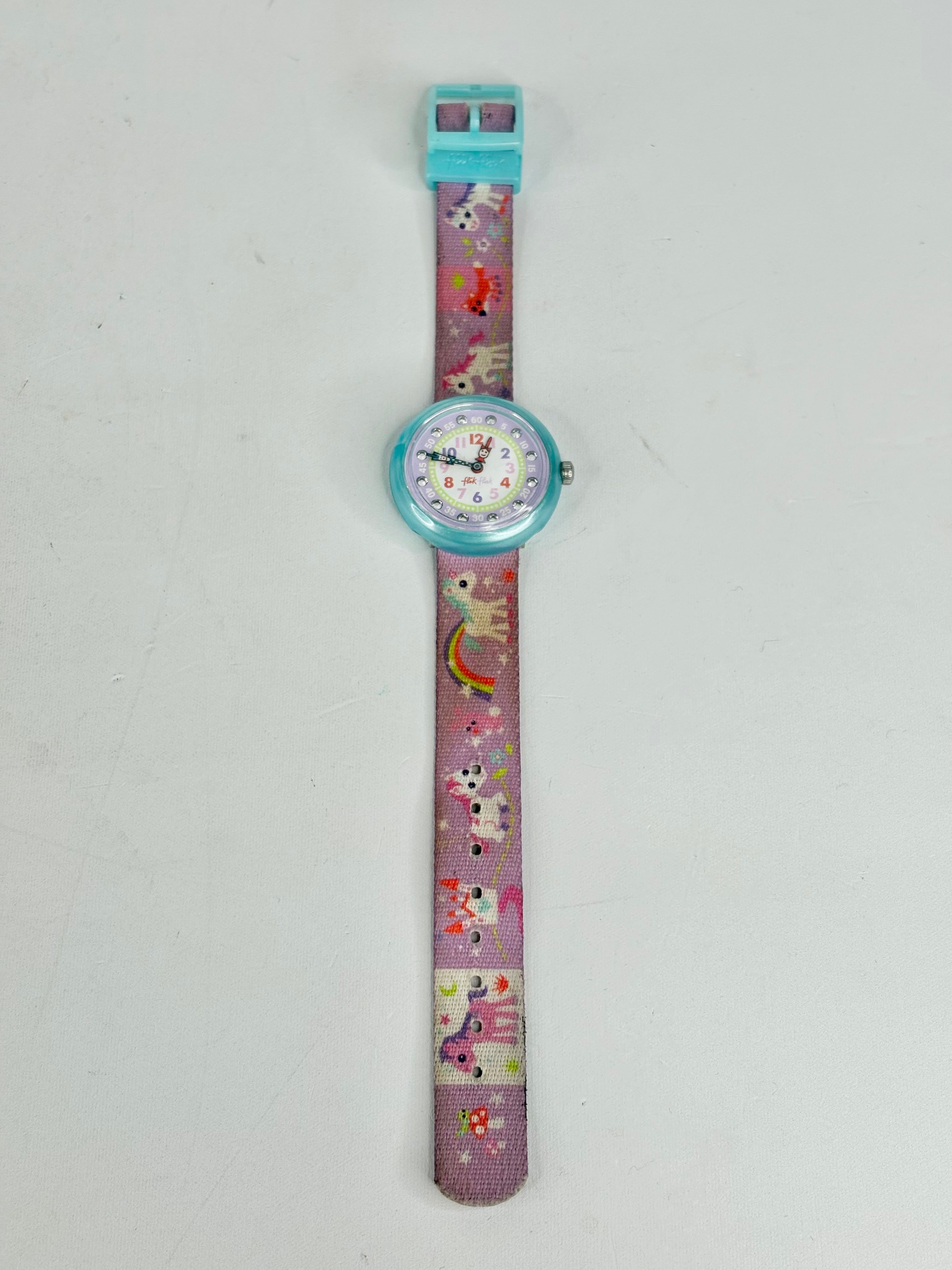 Children's watch with colorful cartoon character strap on a light gray background