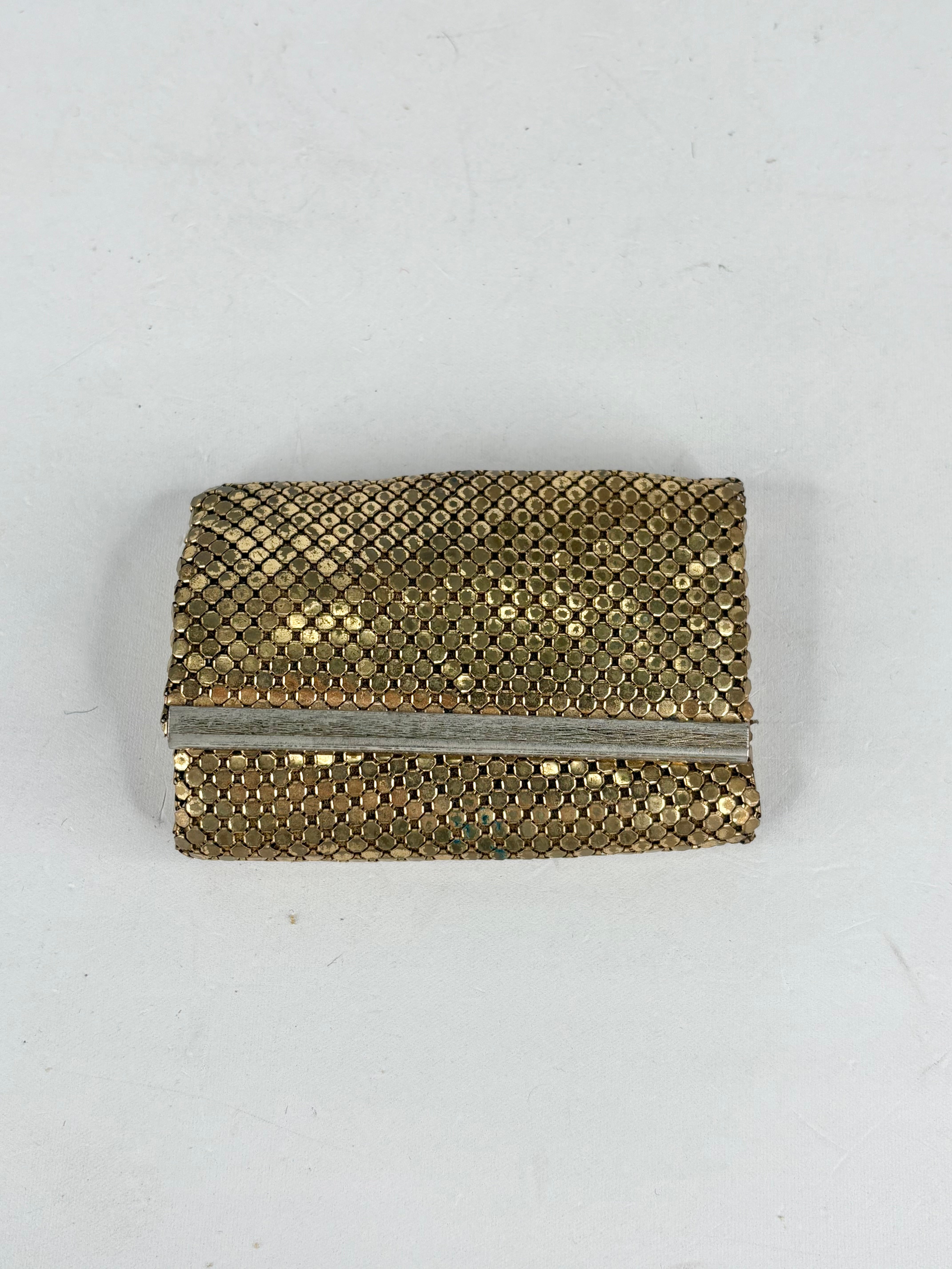 Gold mesh clutch bag on a white background