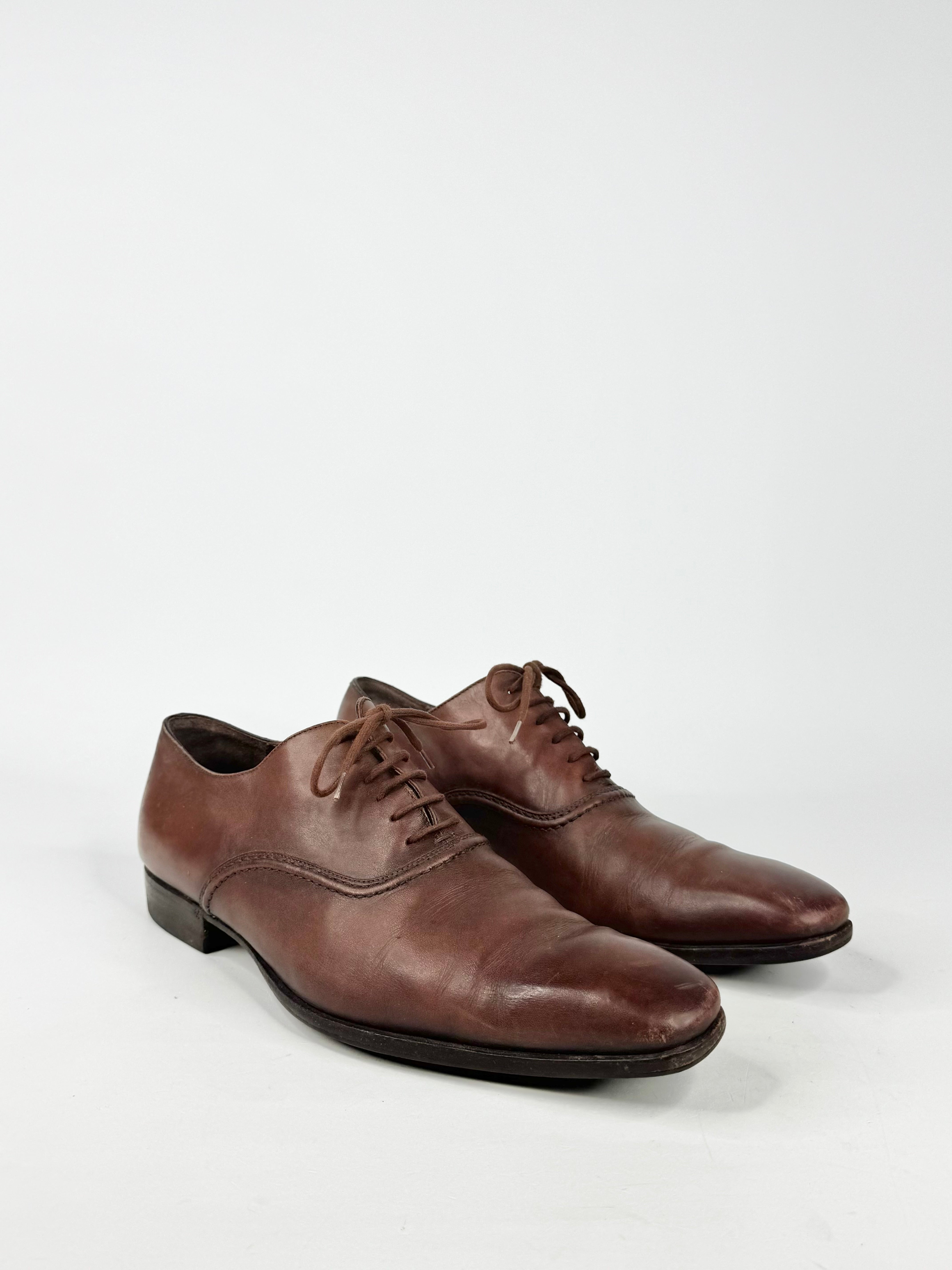 Pair of brown leather dress shoes on a white background