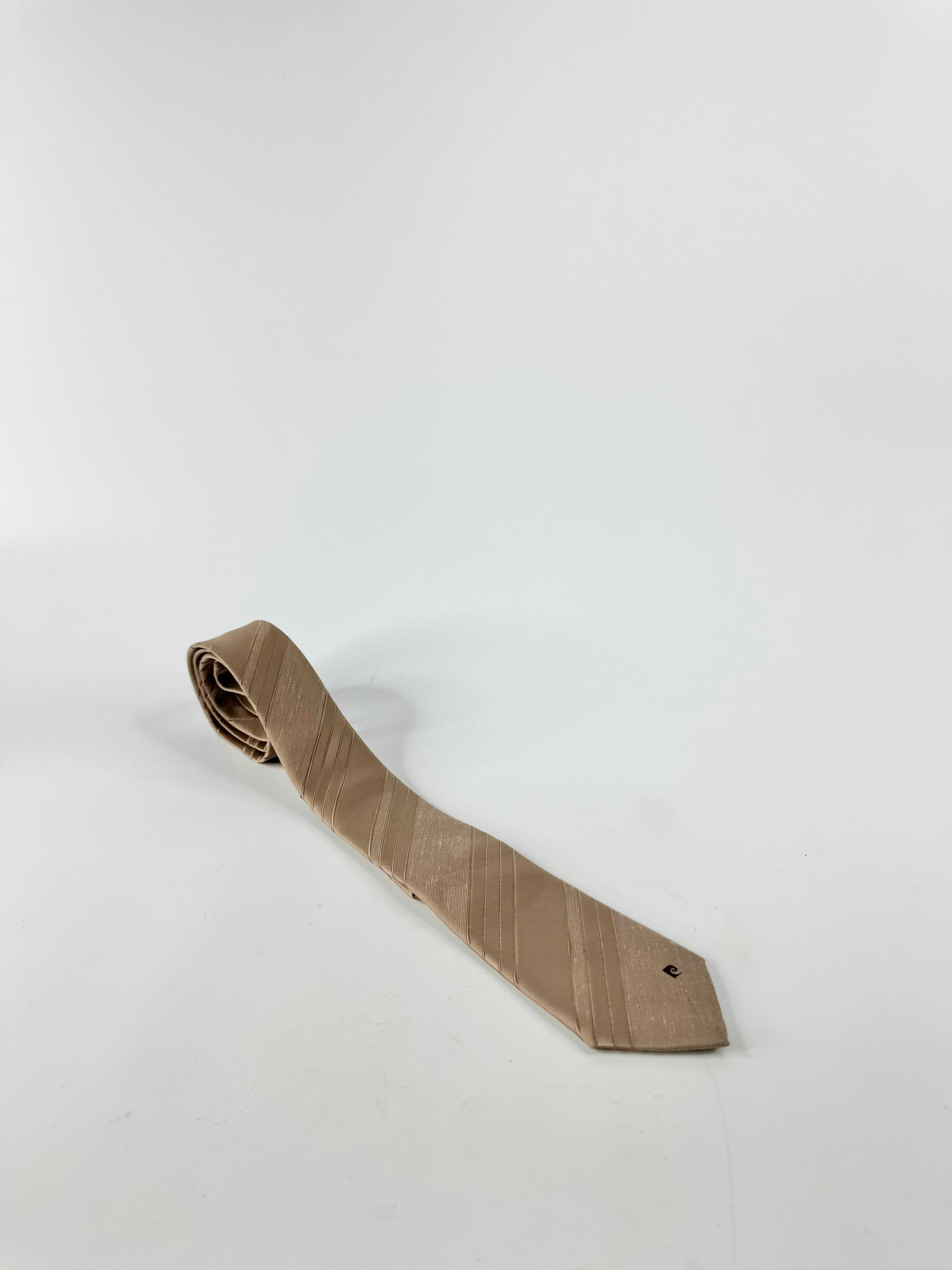 A vintage Pierre Cardin taupe tie on a white background.