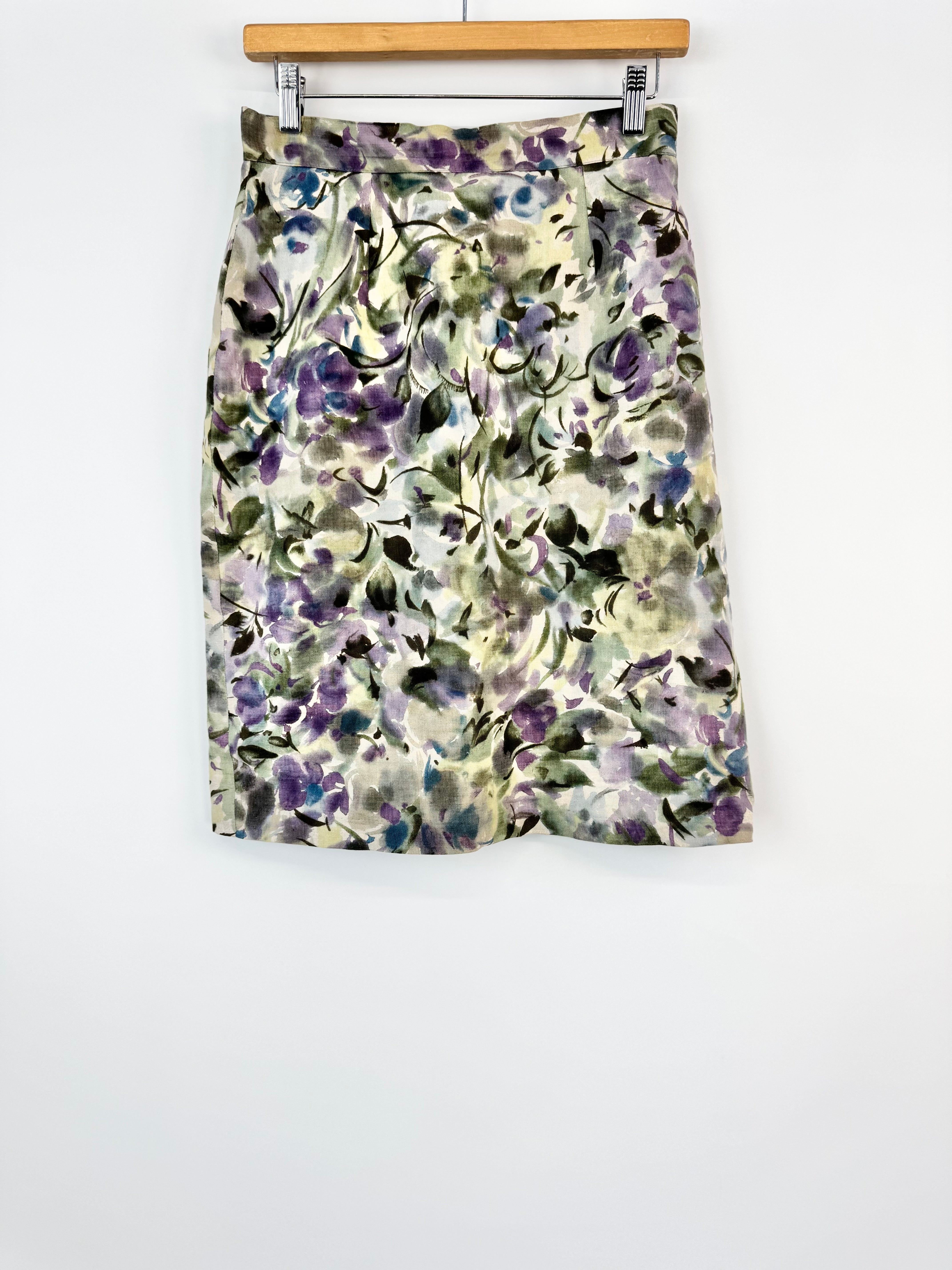 Floral patterned skirt on a hanger against a white background