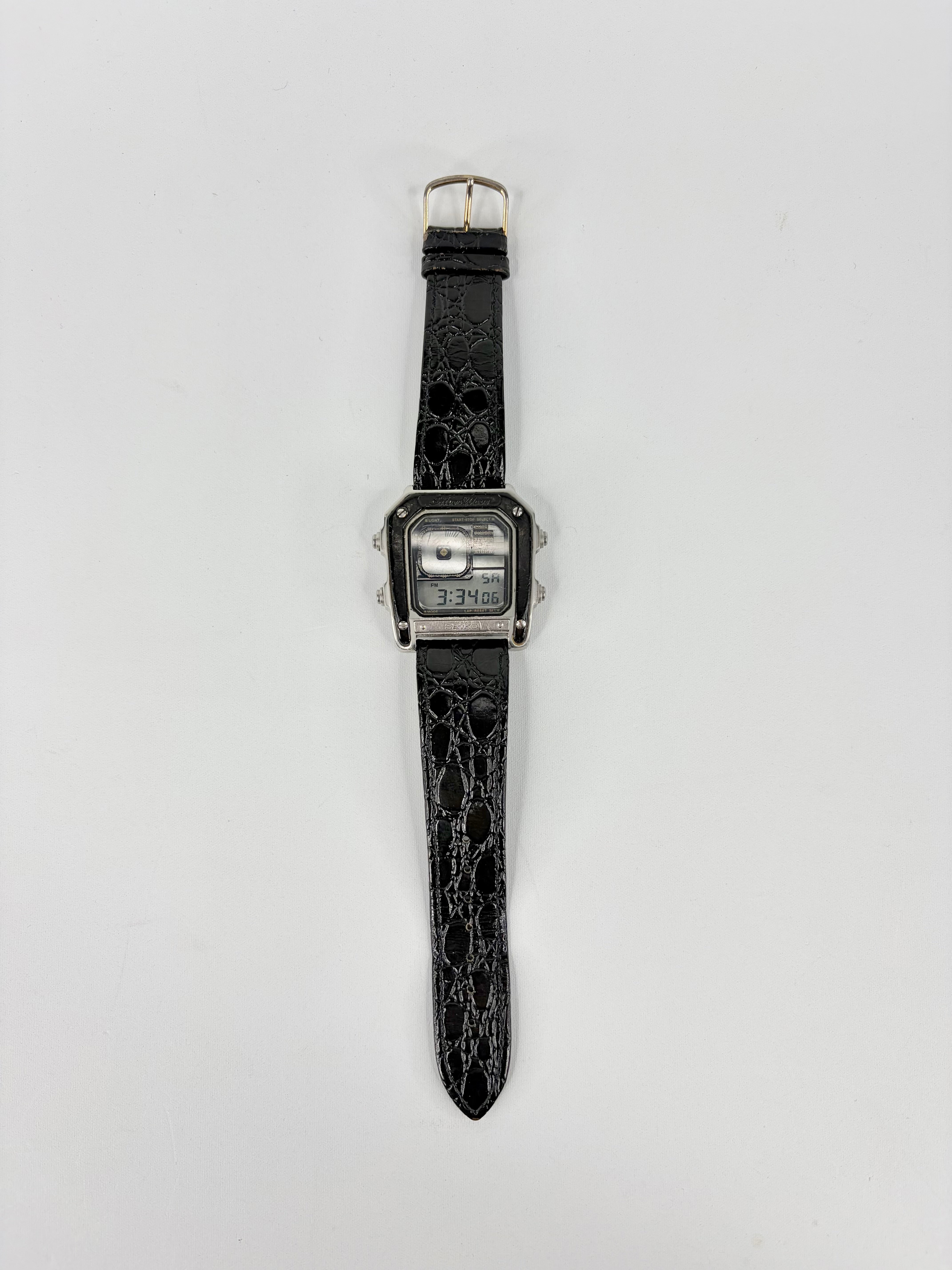 Black textured watch on a light gray background