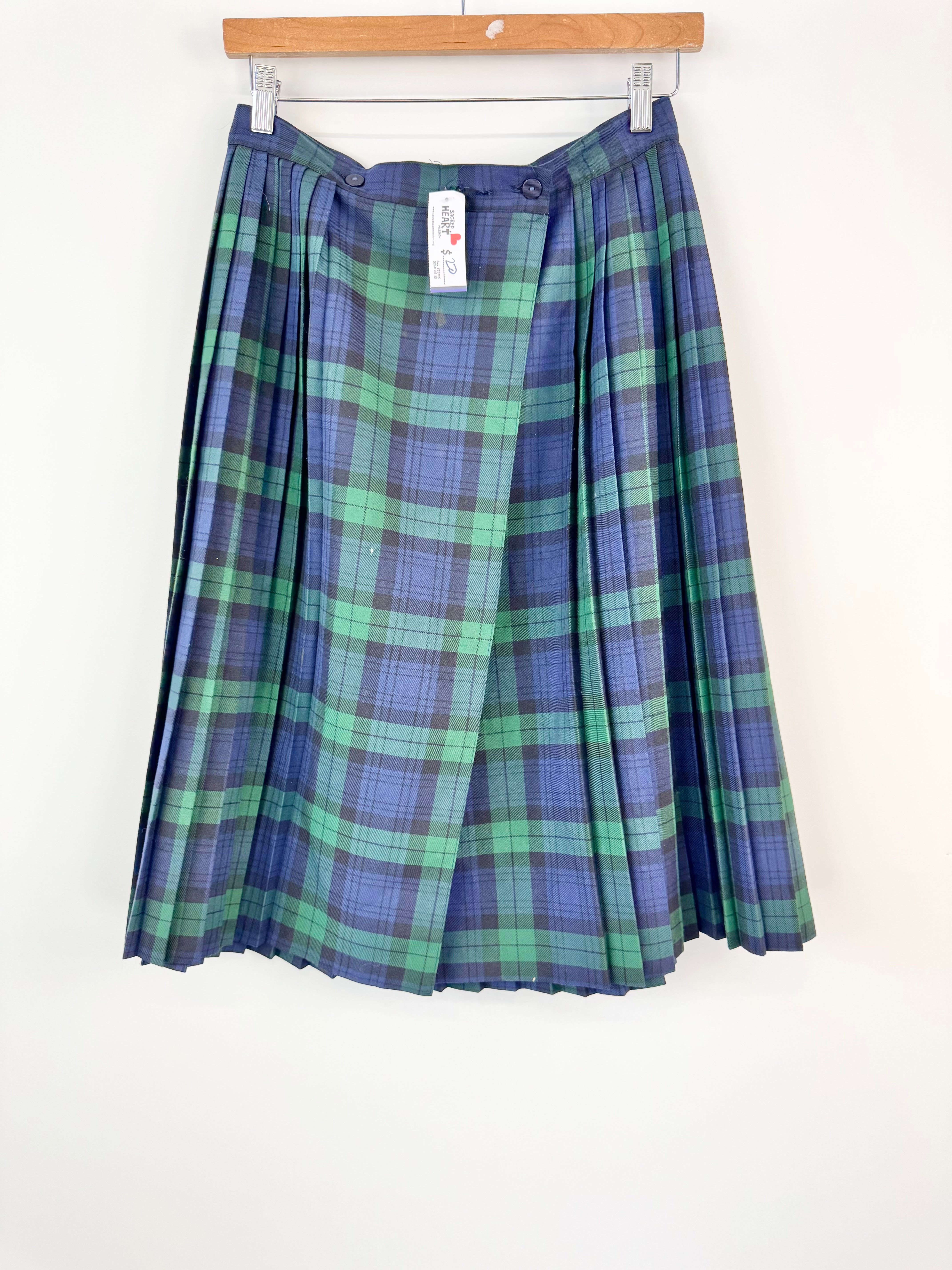 Plaid skirt with blue and green pattern on a white background