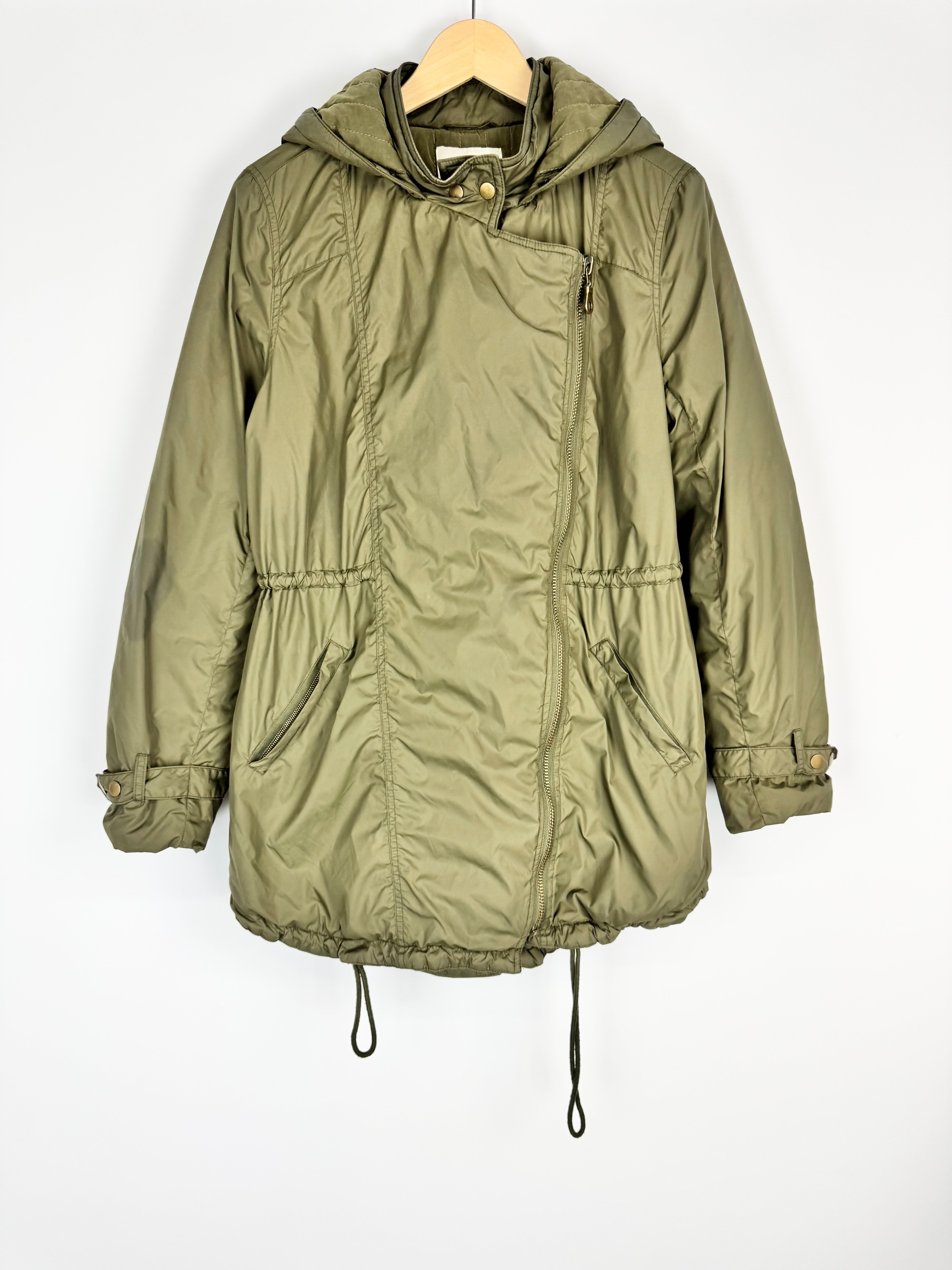 Green jacket on a hanger against a white background
