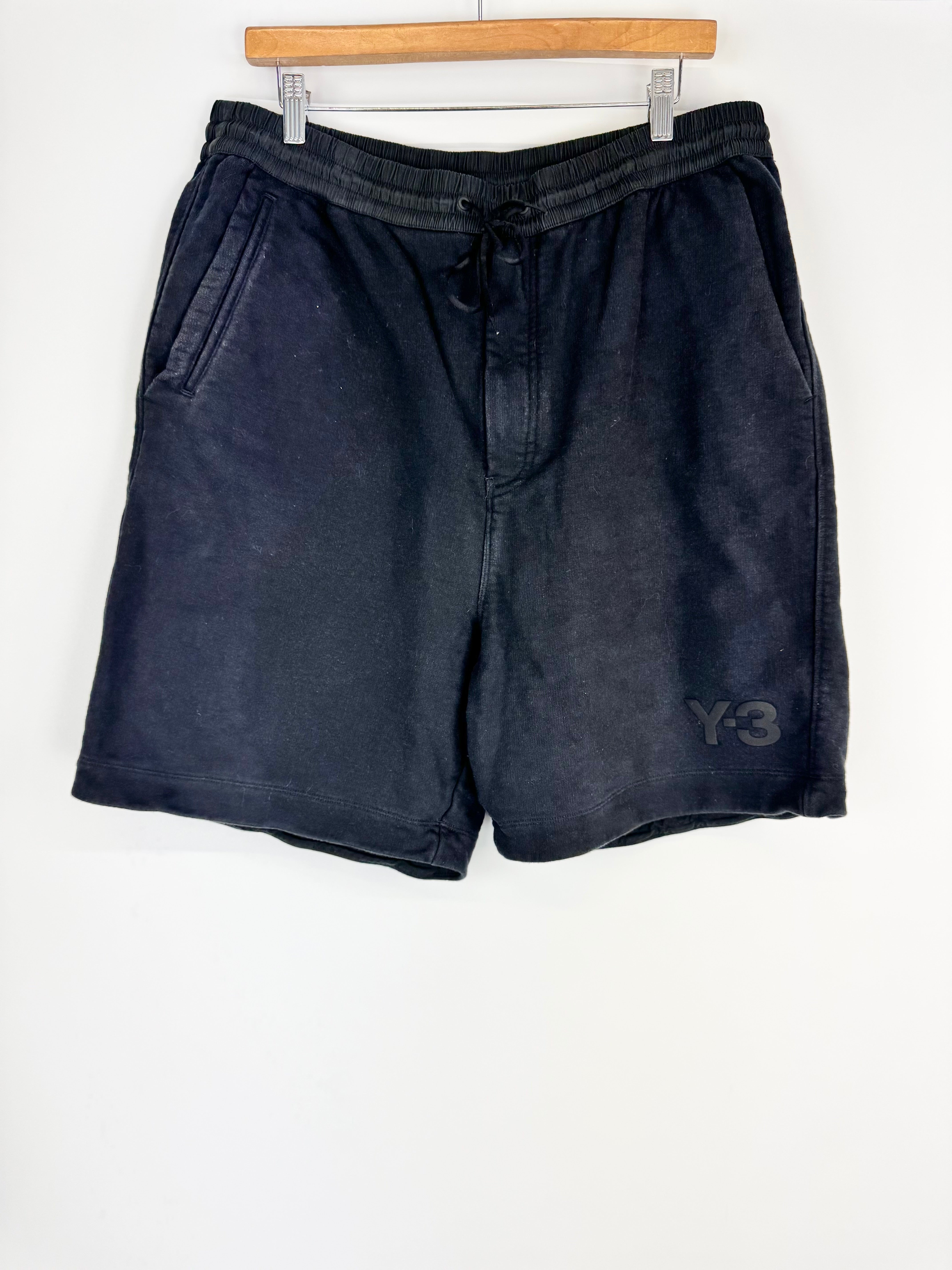 Black shorts with a brand logo on a white background