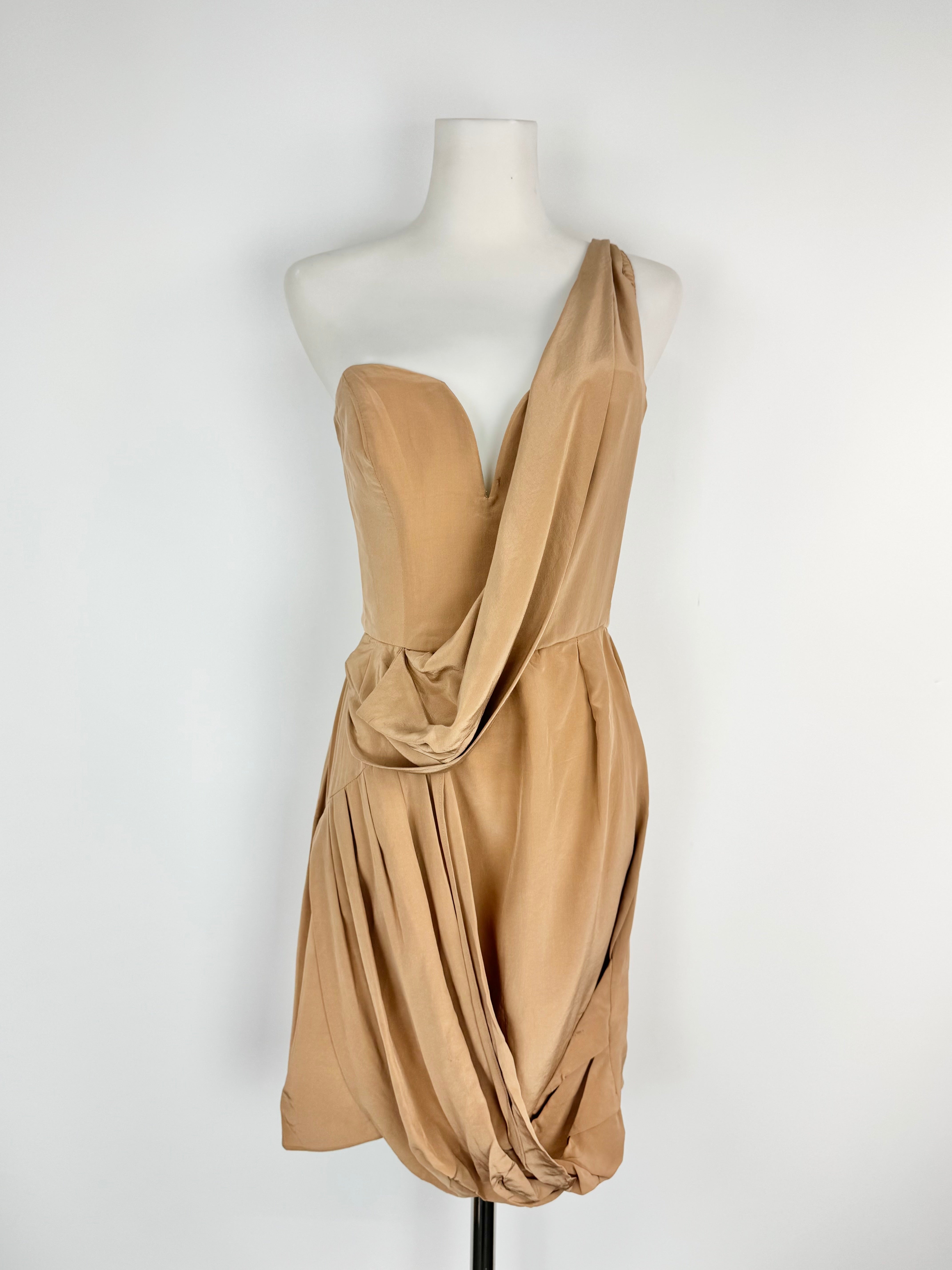 Beige one-shoulder dress on a mannequin against a white background