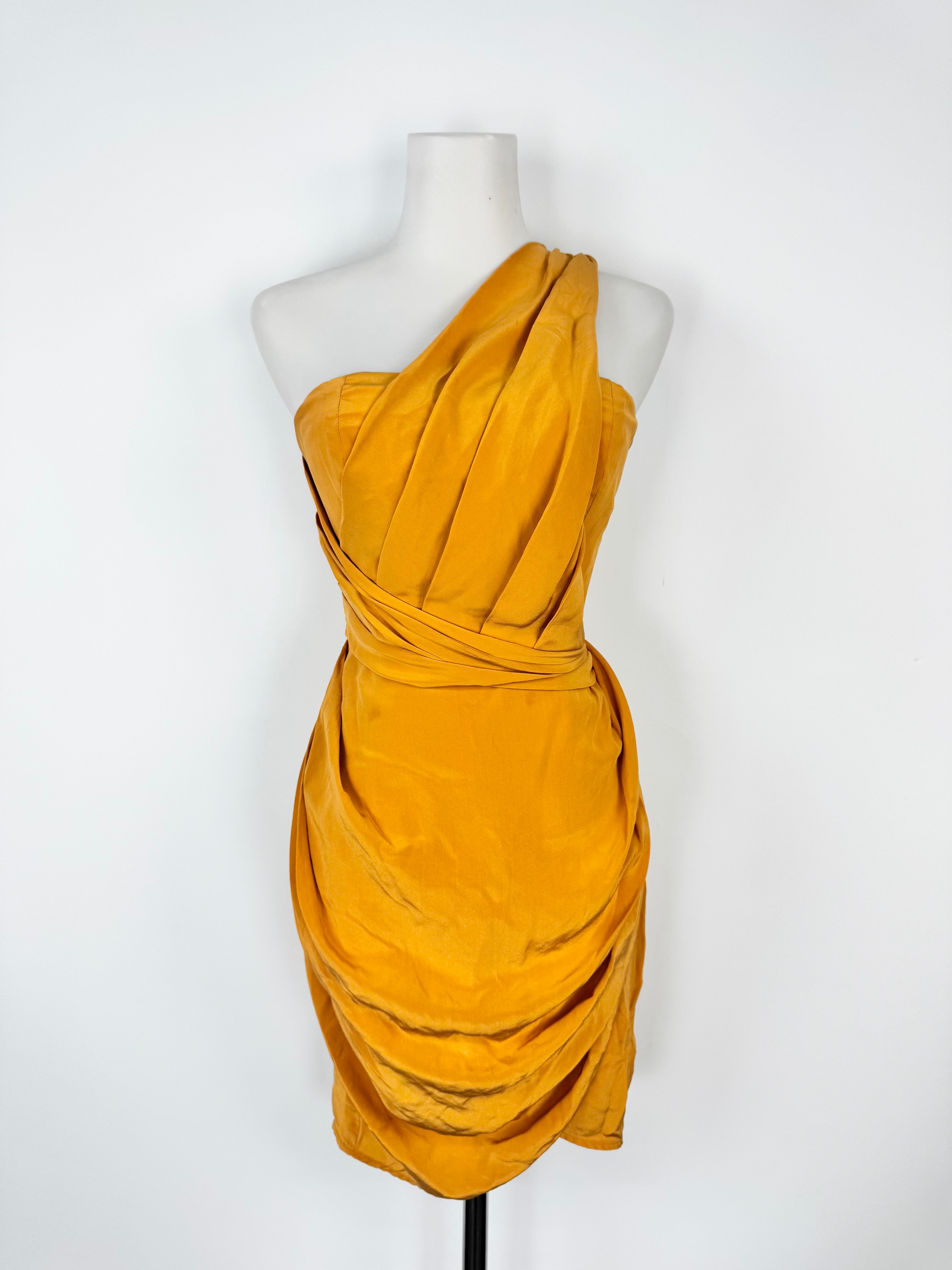 Mustard yellow one-shoulder dress on a mannequin against a white background