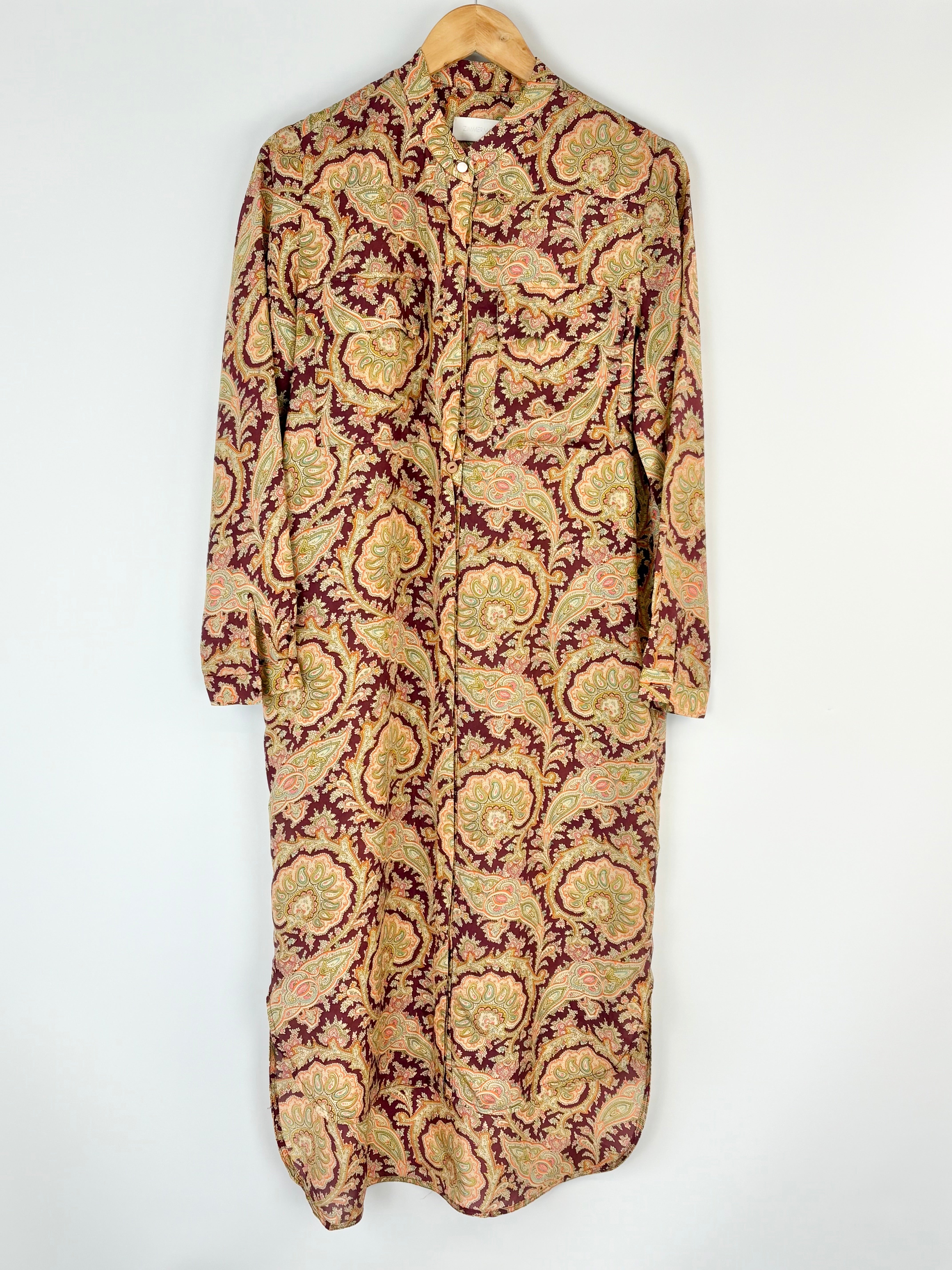 Long patterned Zimmermann dress on a hanger against a white background