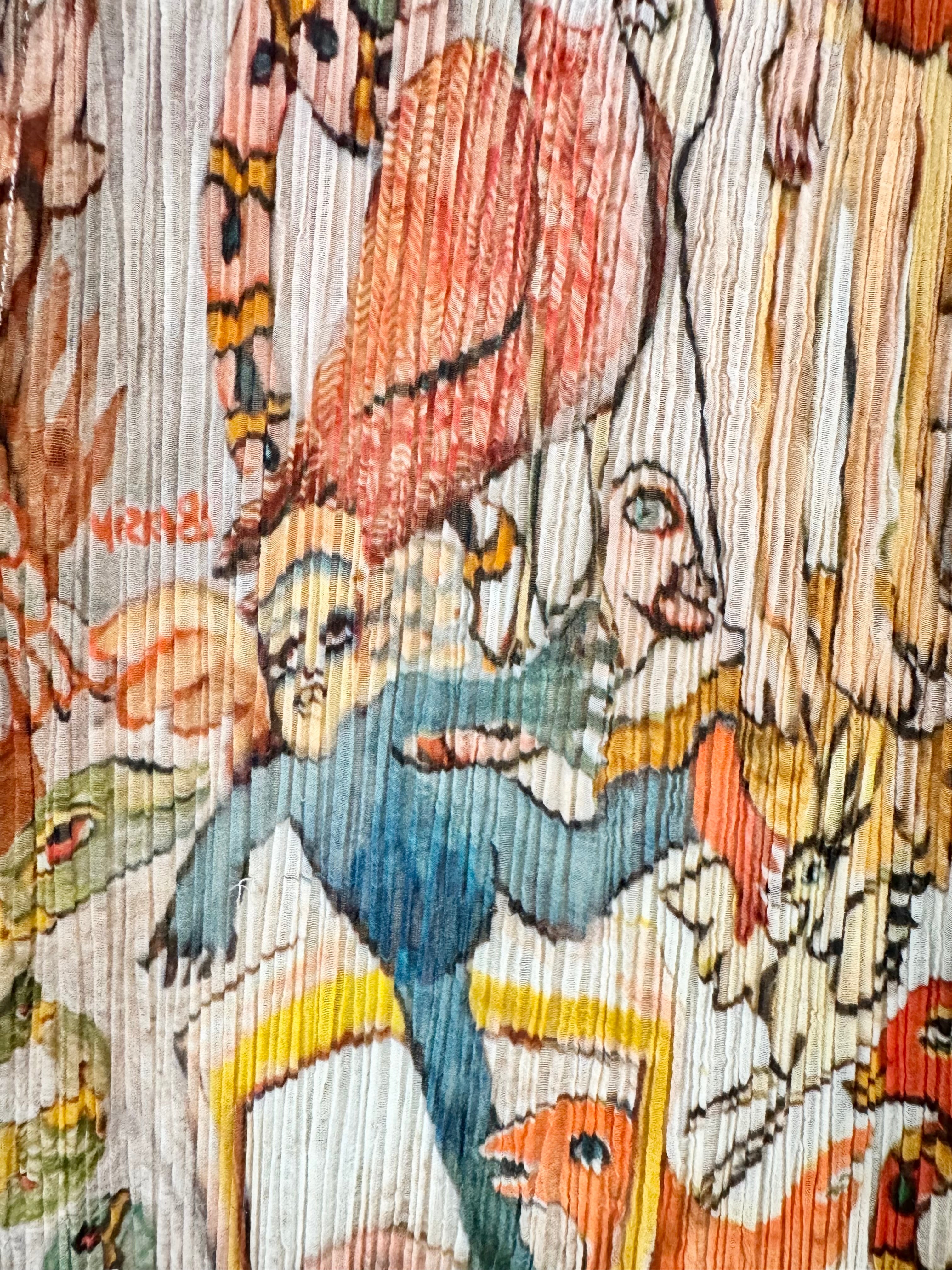 Close-up of a colorful fabric with intricate patterns and characters.