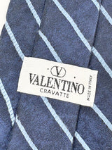 Valentino cravatte with label on a blue and white checkered fabric background