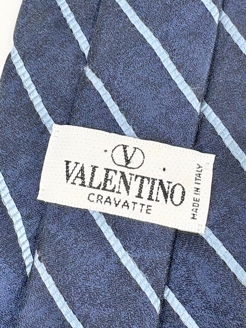 Valentino cravatte with label on a blue and white checkered fabric background