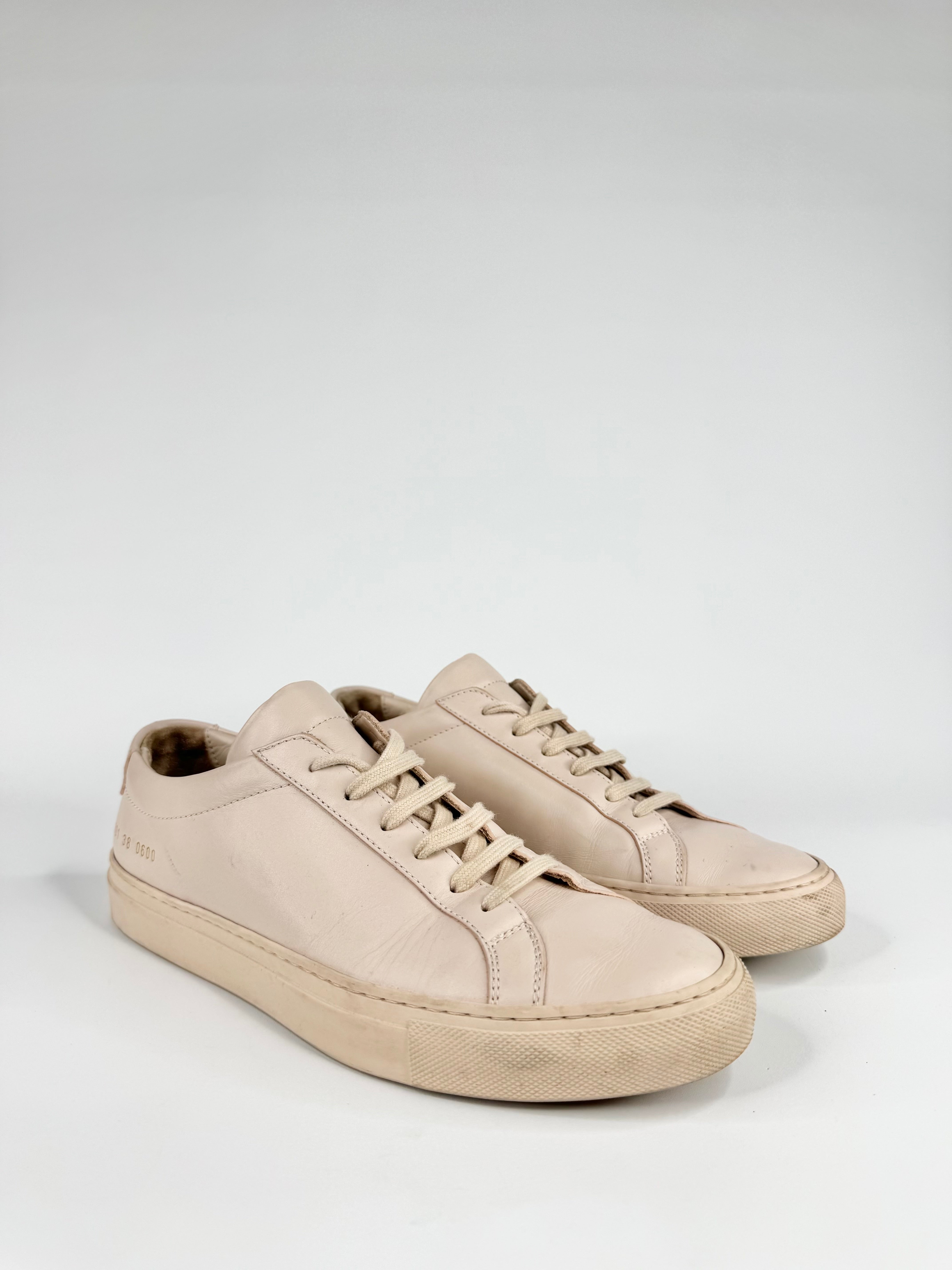 Beige sneakers on a light gray background